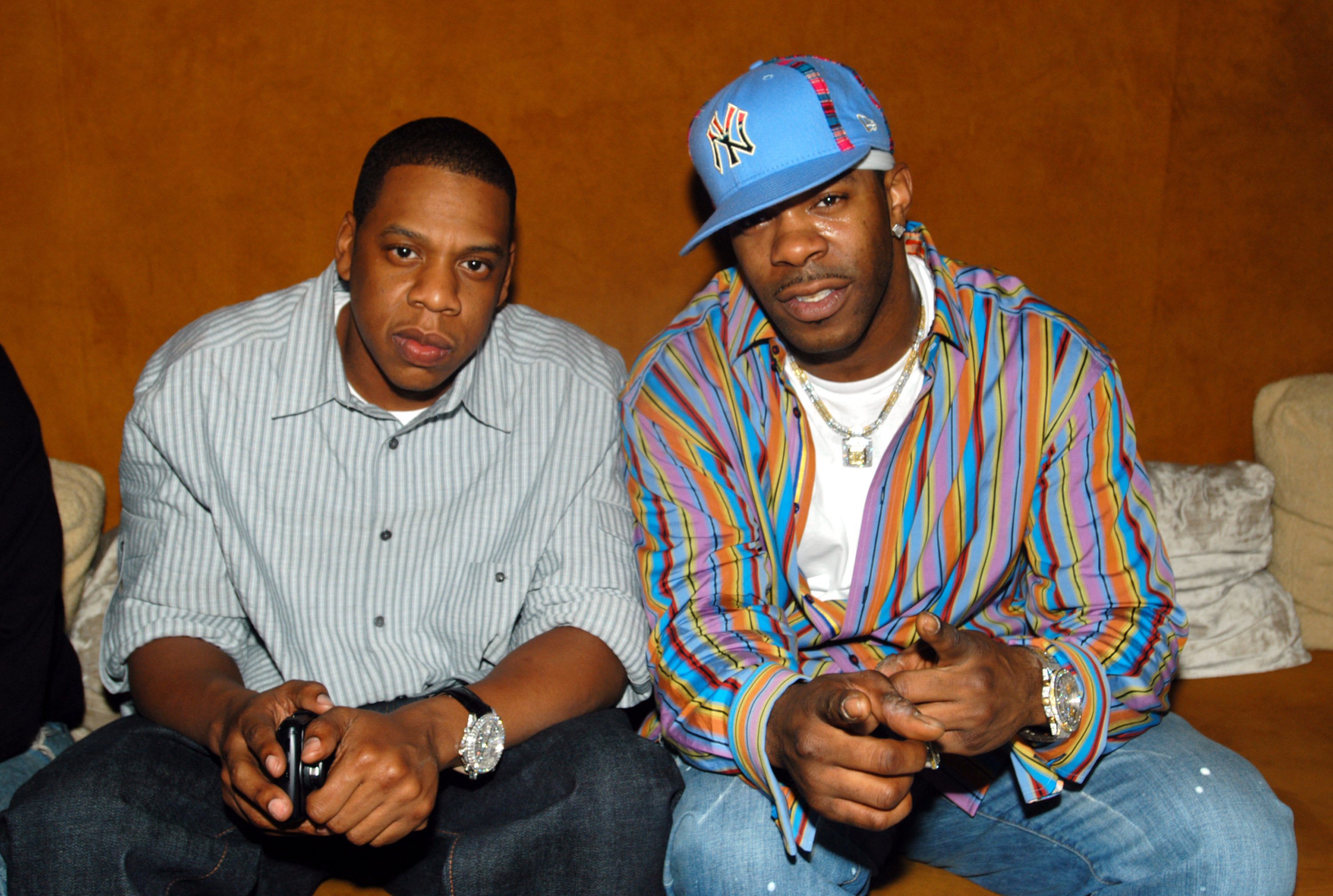 Jay-Z and Busta Rhymes sitting at the 40/40 Club