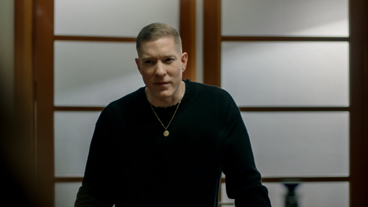 Joseph Sikora as Tommy Egan wearing a black shirt and glaring into the camera