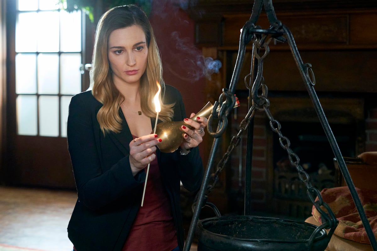 Katherine Barrell, as Joy, holding a lighted candle in the 'Good Witch' series finale.