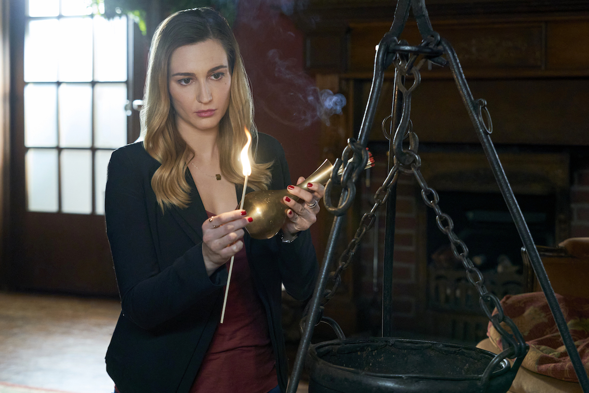 Katherine Barrell, as Joy, holding a lighted candle in the 'Good Witch' series finale