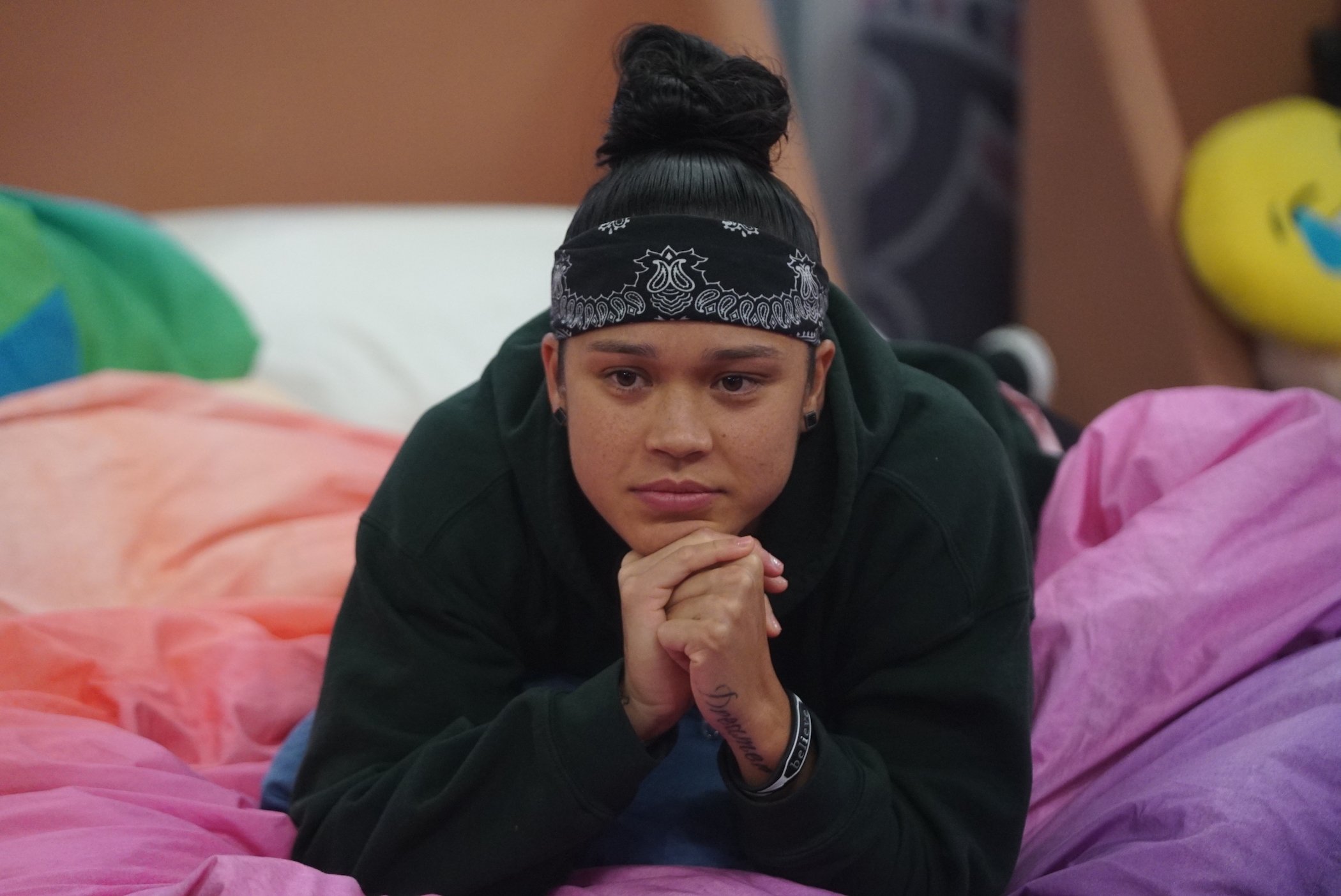 Kaycee Clark from MTV's 'The Challenge' sitting on a bed in 'Big Brother.'