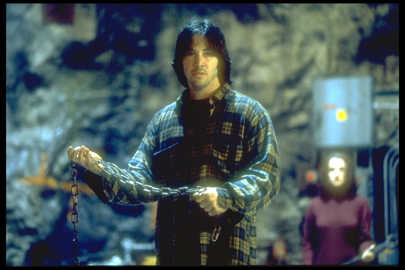 Keanu Reeves swings a chain in Chain Reaction
