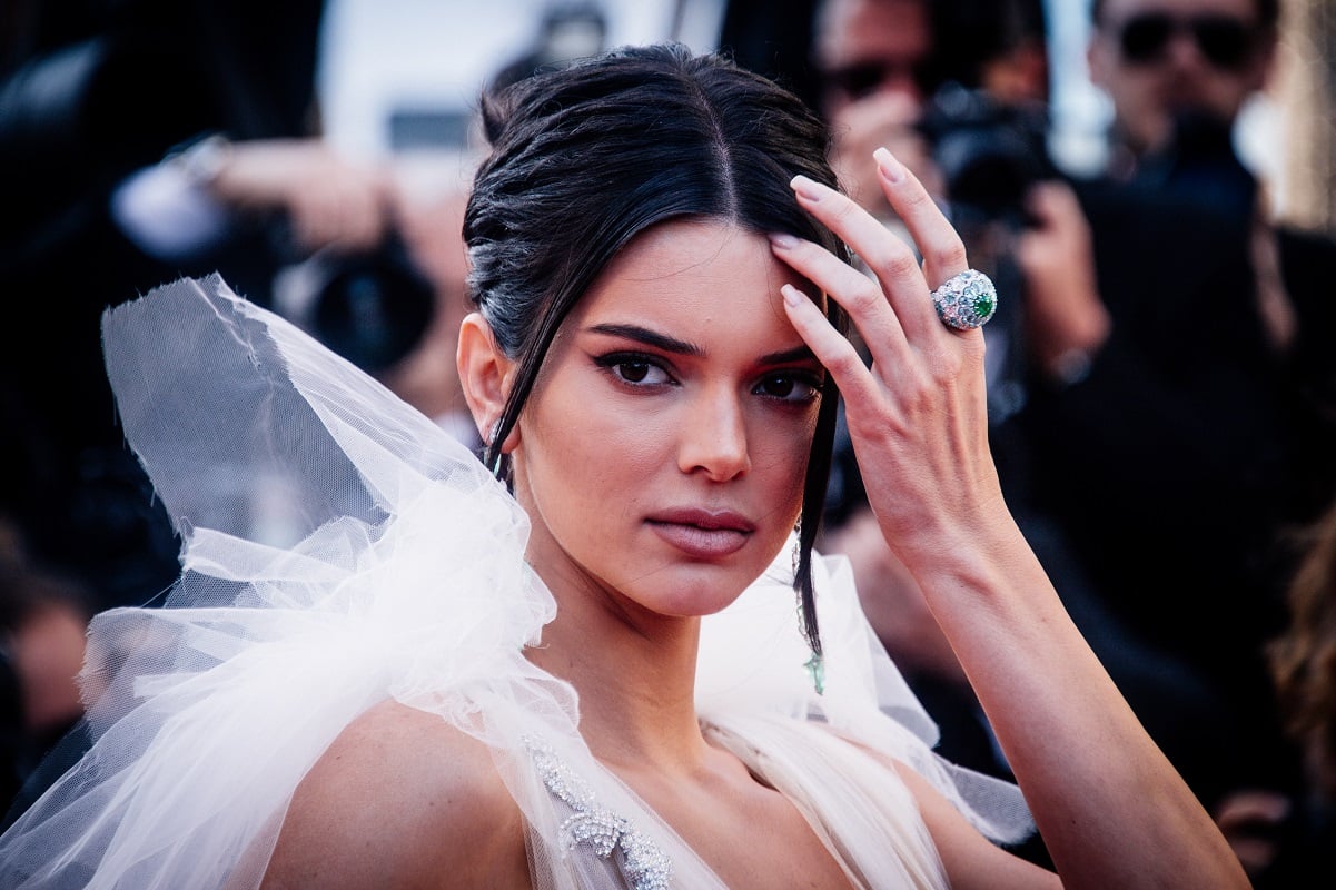 Kendall Jenner wearing a white ensemble with her hair pulled back at the Cannes Film Festival in 2018
