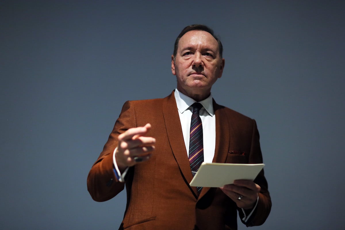 Kevin Spacey holding a piece of paper and pointing