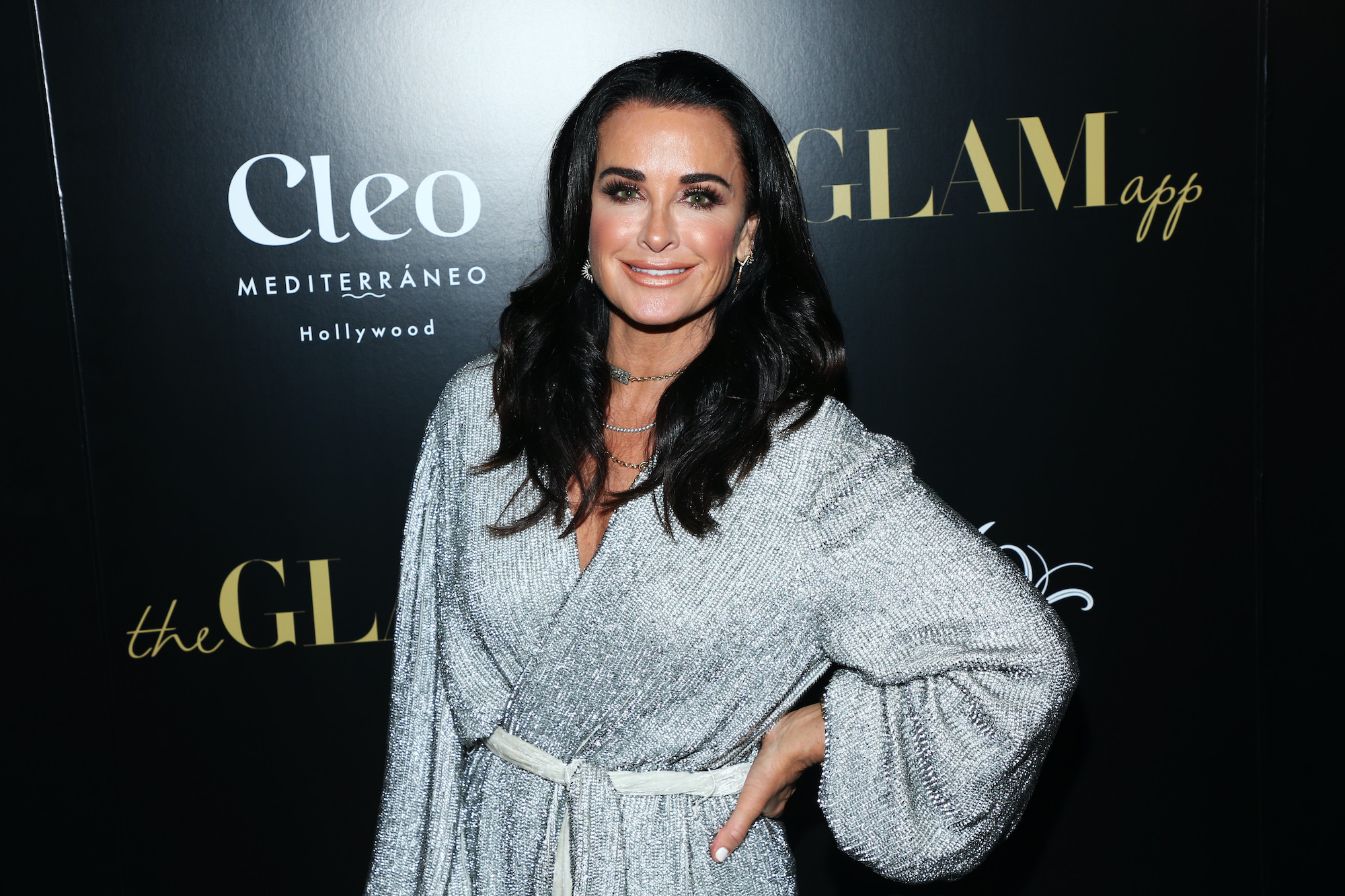 Kyle Richards smiling in front of a black background