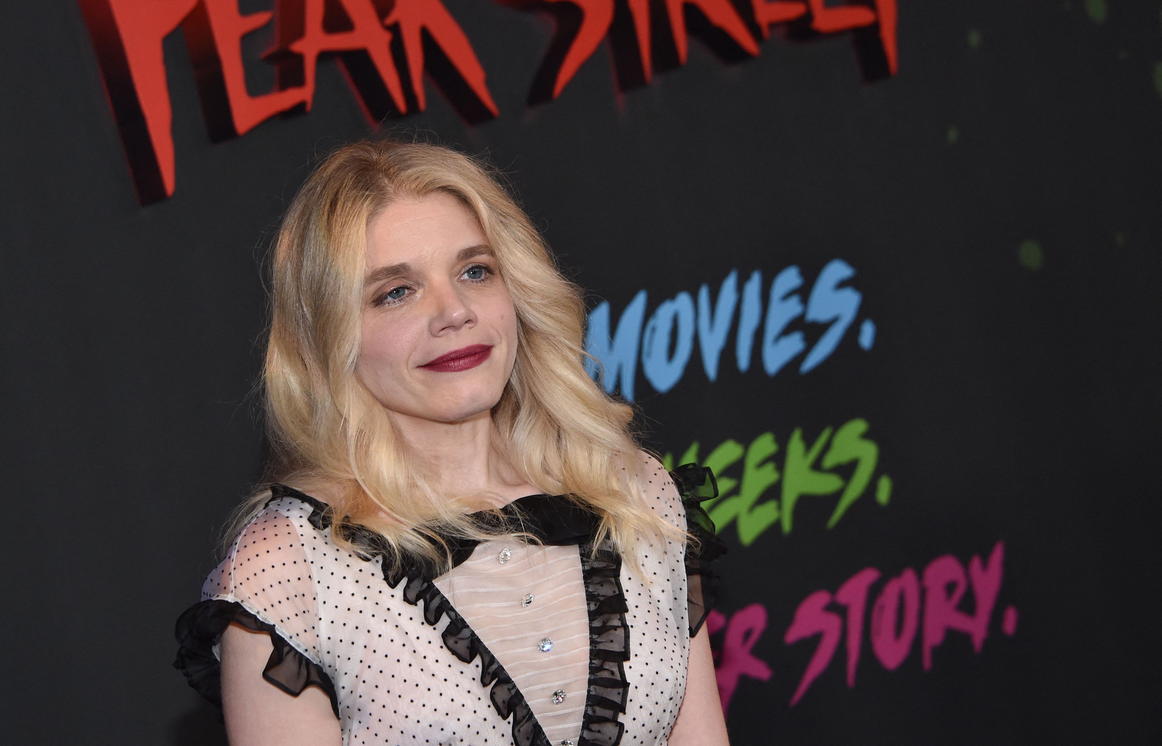 Netflix's Fear Street trilogy director Leigh Janiak wearing a black and white polkadot dress and red lipstick at the film premiere