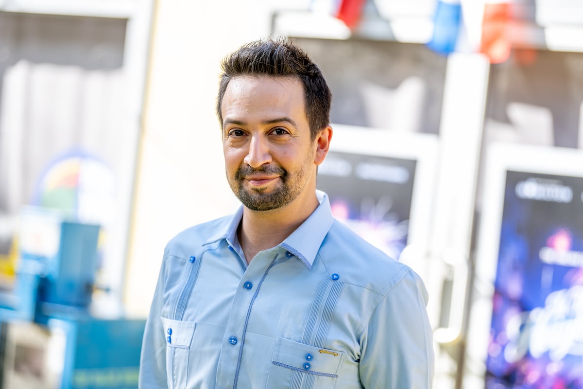 Lin-Manuel Miranda smiles in a blue shirt at the ‘In The Heights’ premiere at the Tribeca Film Festival