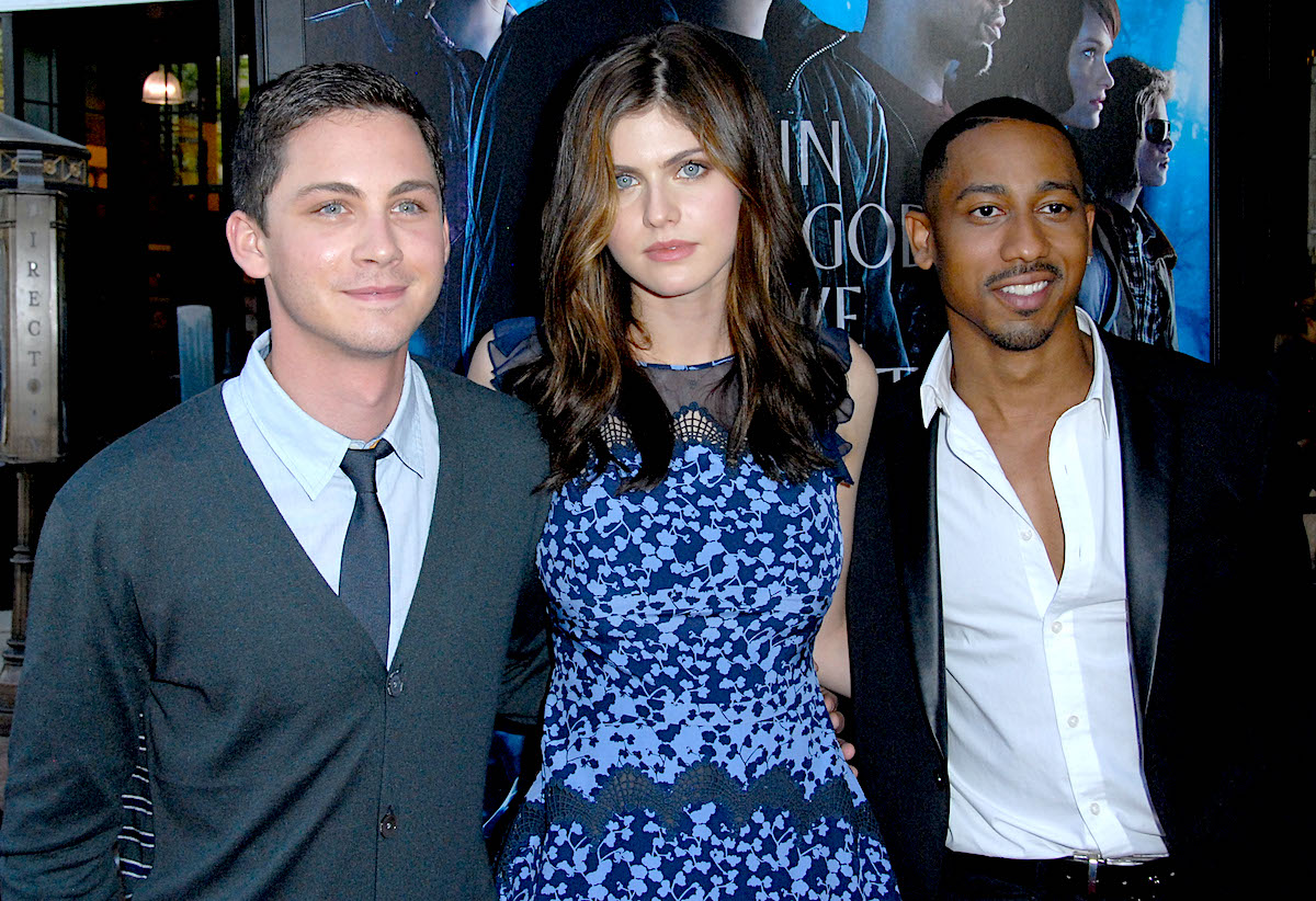 Logan Lerman, Alexandra Daddario, and Brandon T. Jackson at the premiere of 'Percy Jackson: Sea Of Monsters' in 2013. They stand side-by-side in front of a backdrop with the movie title on it.