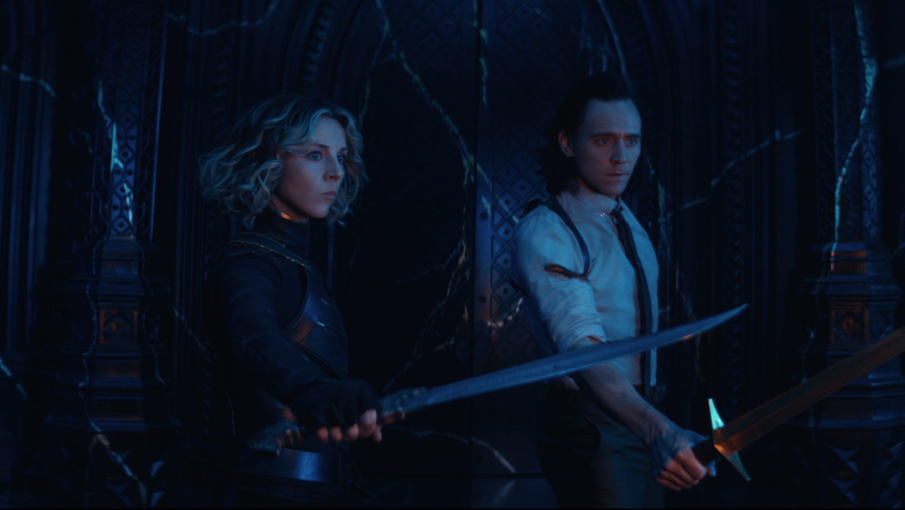 Loki (Tom Hiddleston) and Sylvie (Sophia Di Martino) holding out knives and learning who's behind the TVA, leaving questions for Season 2 of this TV series
