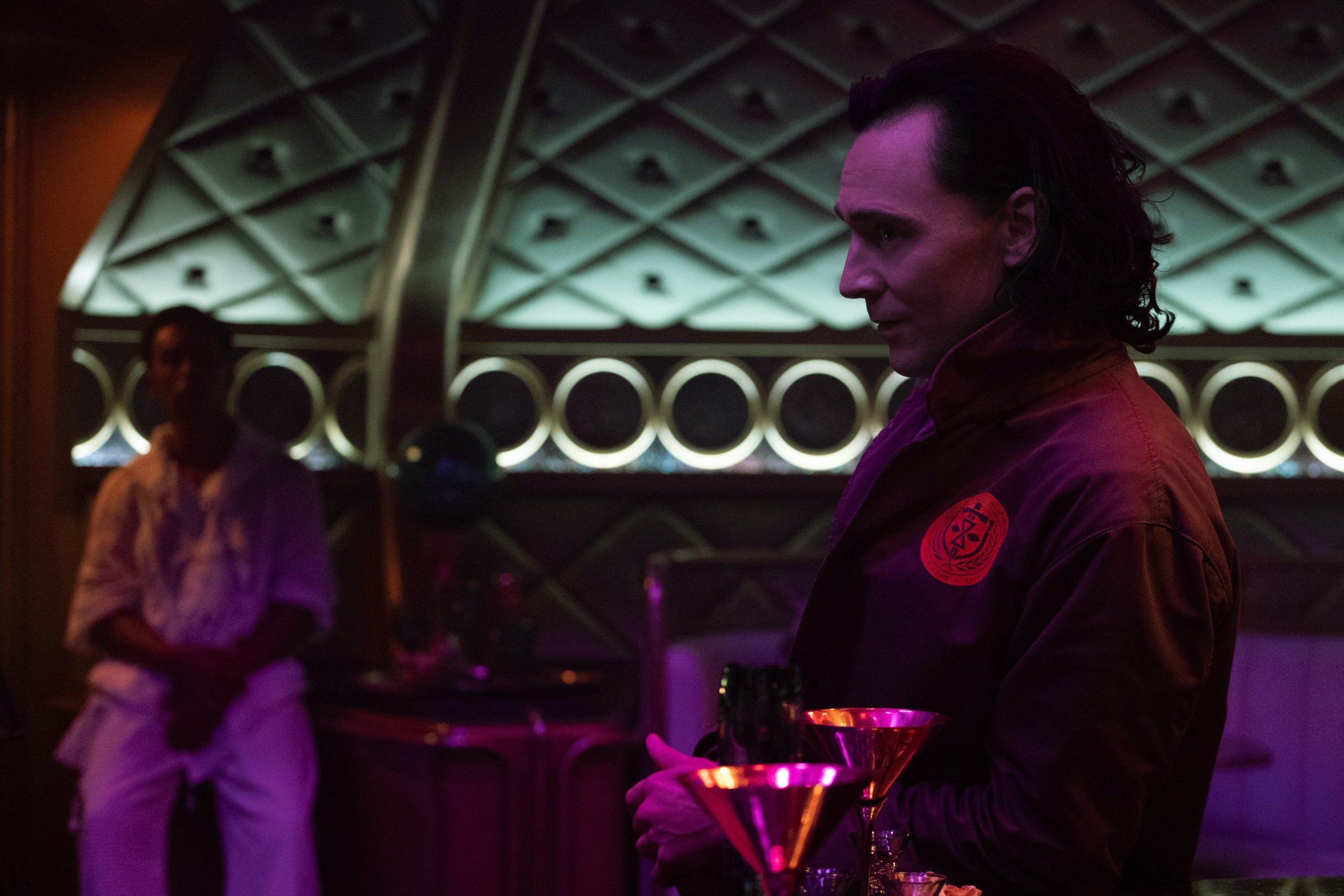 Tom Hiddleston as Loki about to drink and sing on Lamentis-1 in Marvel's 'Loki'