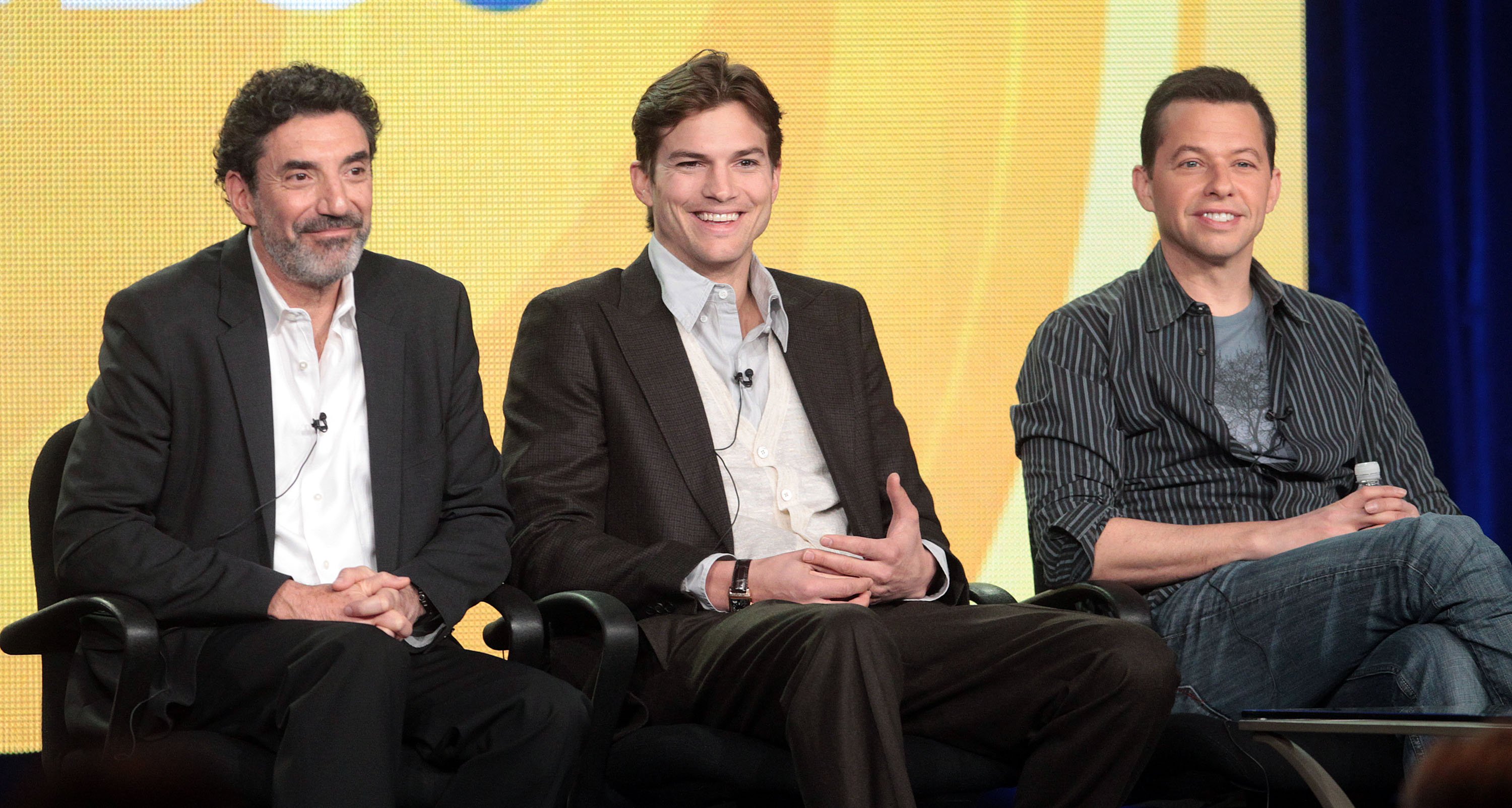Chuck Lorre sits onstage with Ashton Kutcher and Jon Cryer during the 2012 Television Critics Association Press Tour