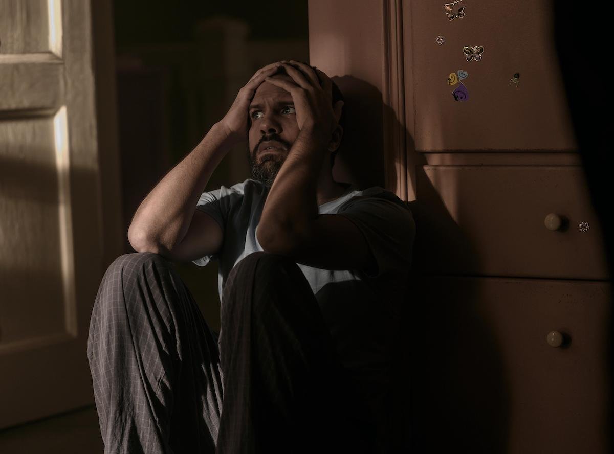 O-T Fagbenle as Luke Bankole in 'The Handmaid's Tale' Season 4 Episode 10, 'The Wilderness.' He crouches on the floor of a nursery with his hands on his head and a concerned look on his face.