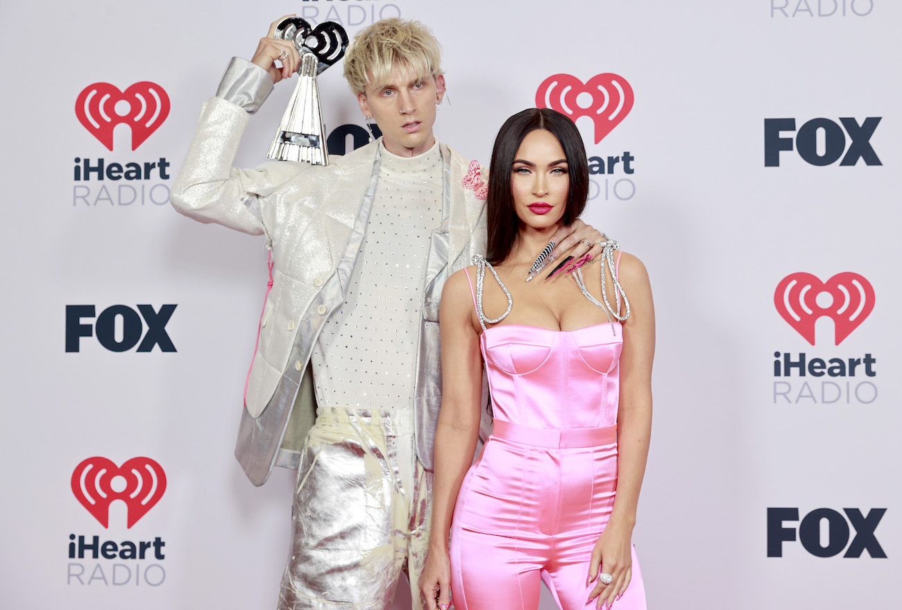 Machine Gun Kelly and Megan Fox posing together in front of white background