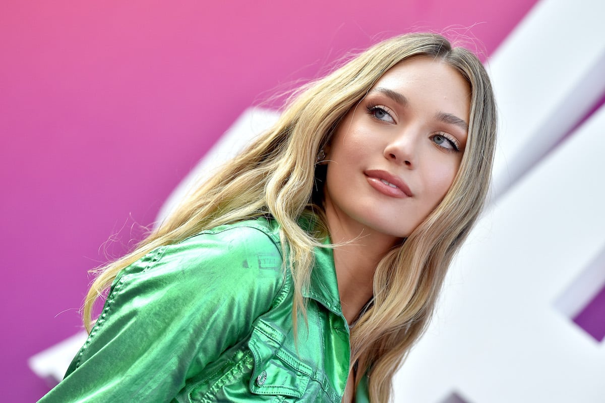 'West Side Story' star Maddie Ziegler smirks at the camera in a green outfit