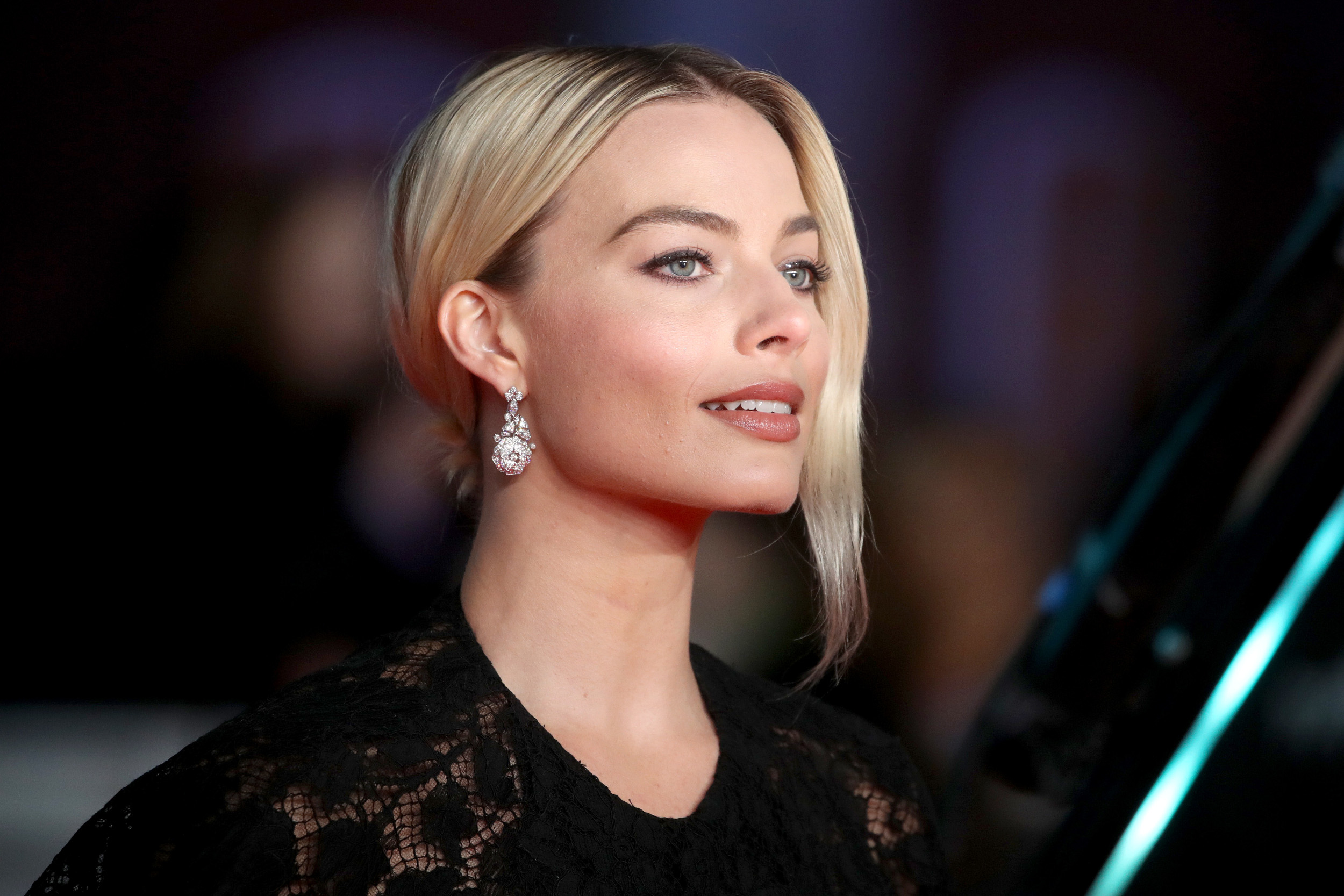 Harley Quinn actor Margot Robbie wearing a black dress on the red carpet