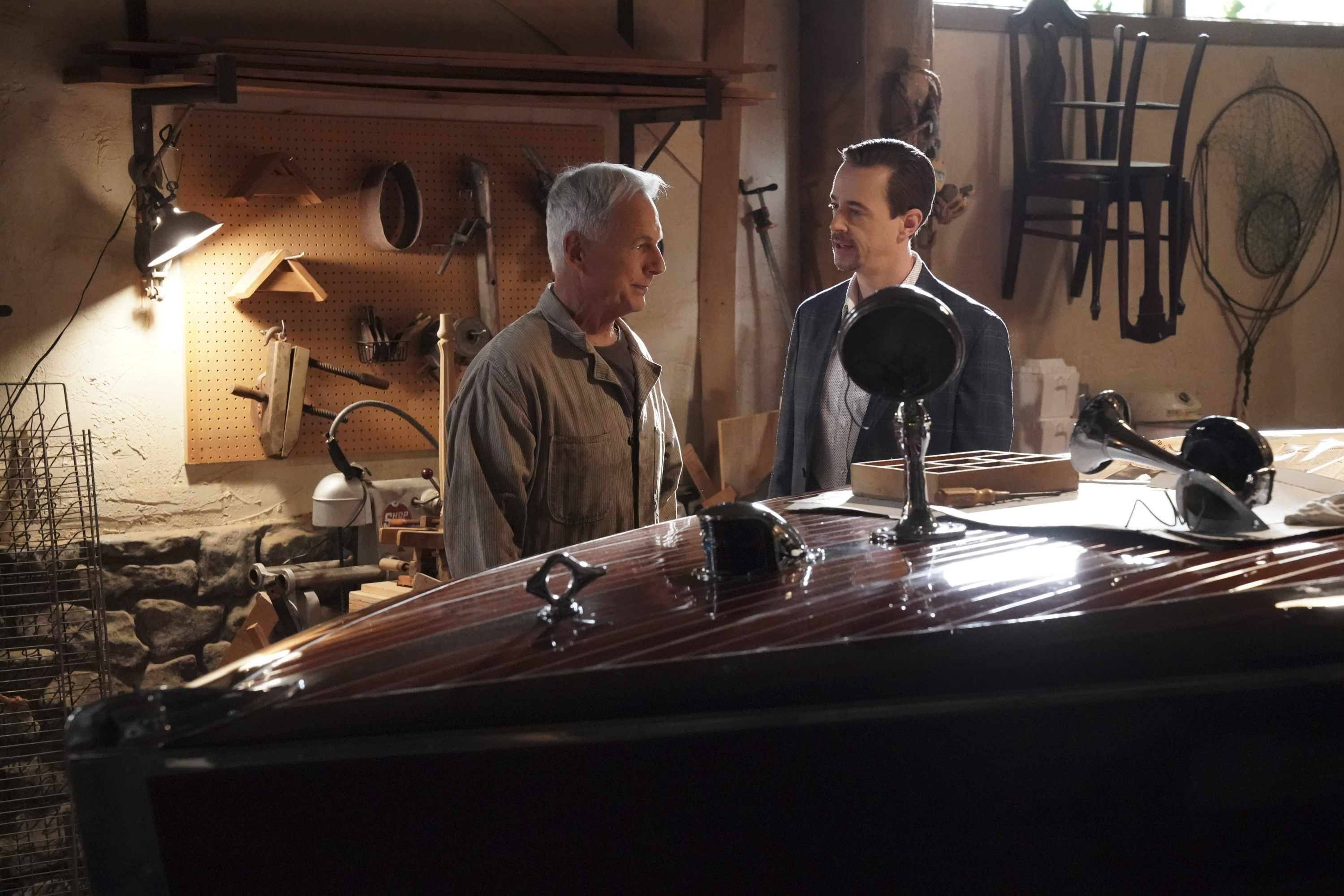 Mark Harmon and Sean Murray stand in front of Gibbs' boat on the set of NCIS. 