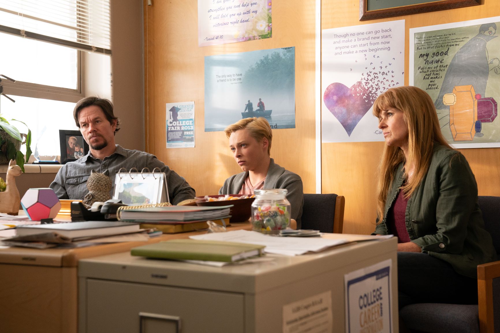 Mark Wahlberg, Reid Miller and Connie Britton sit in the school office