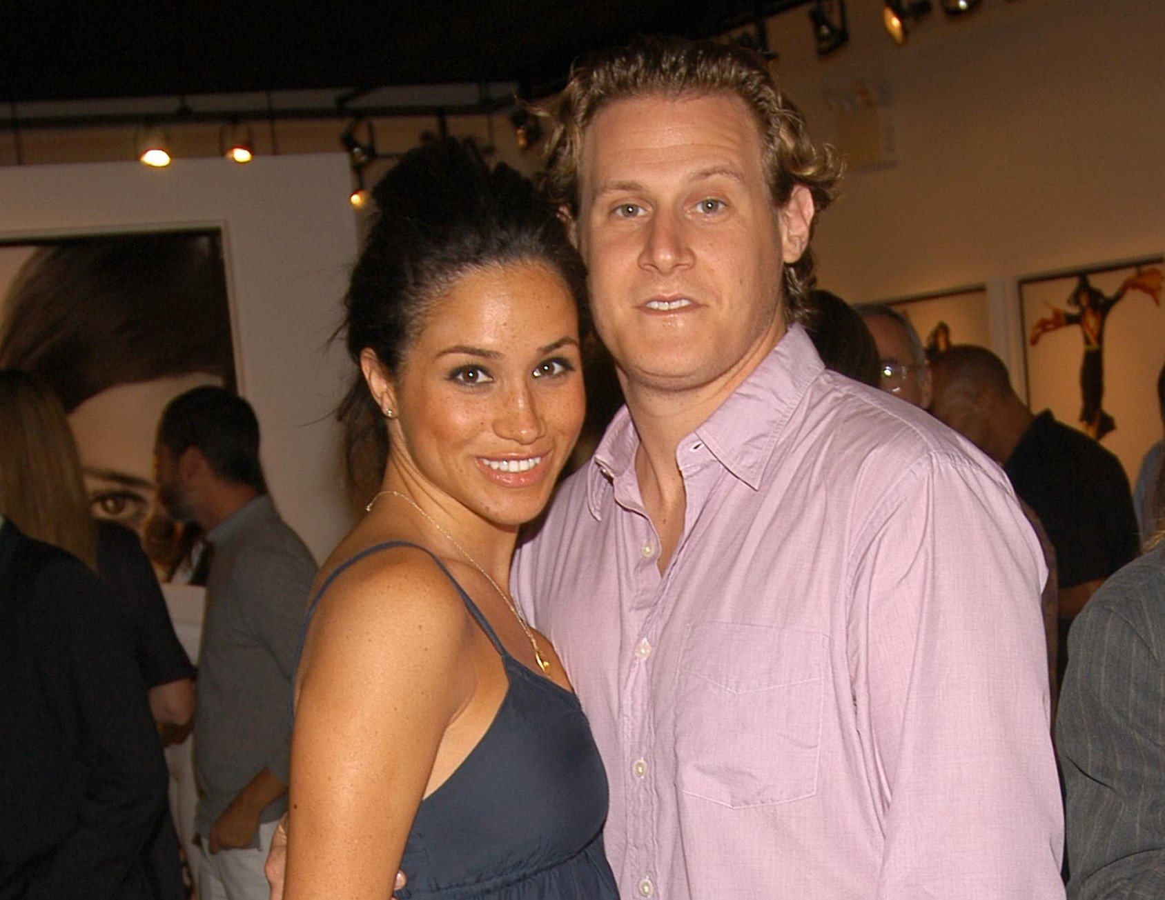Meghan Markle posing with Trevor Engelson at a photo exhibit in 2006
