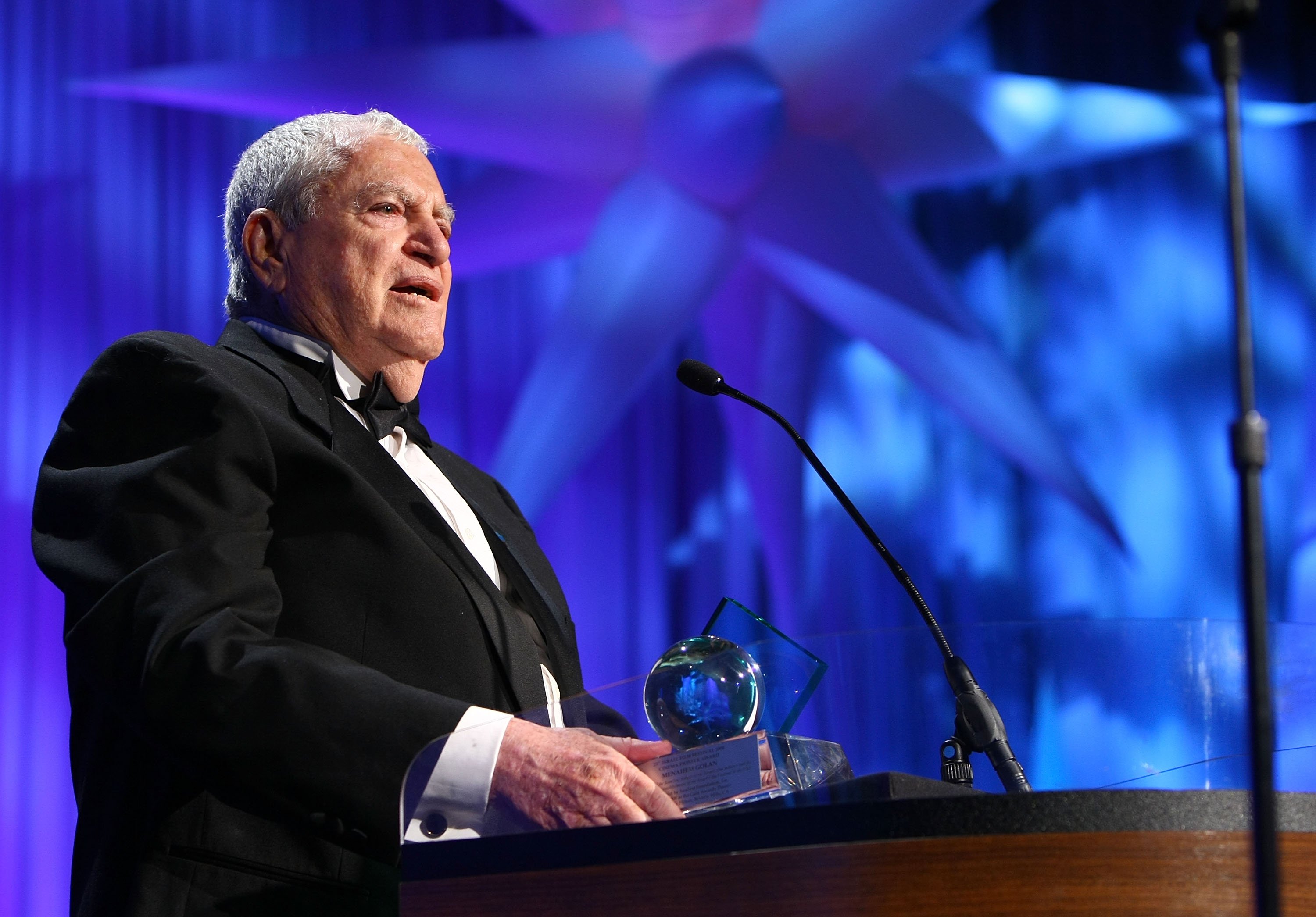 Menahem Golan speaks at a podium