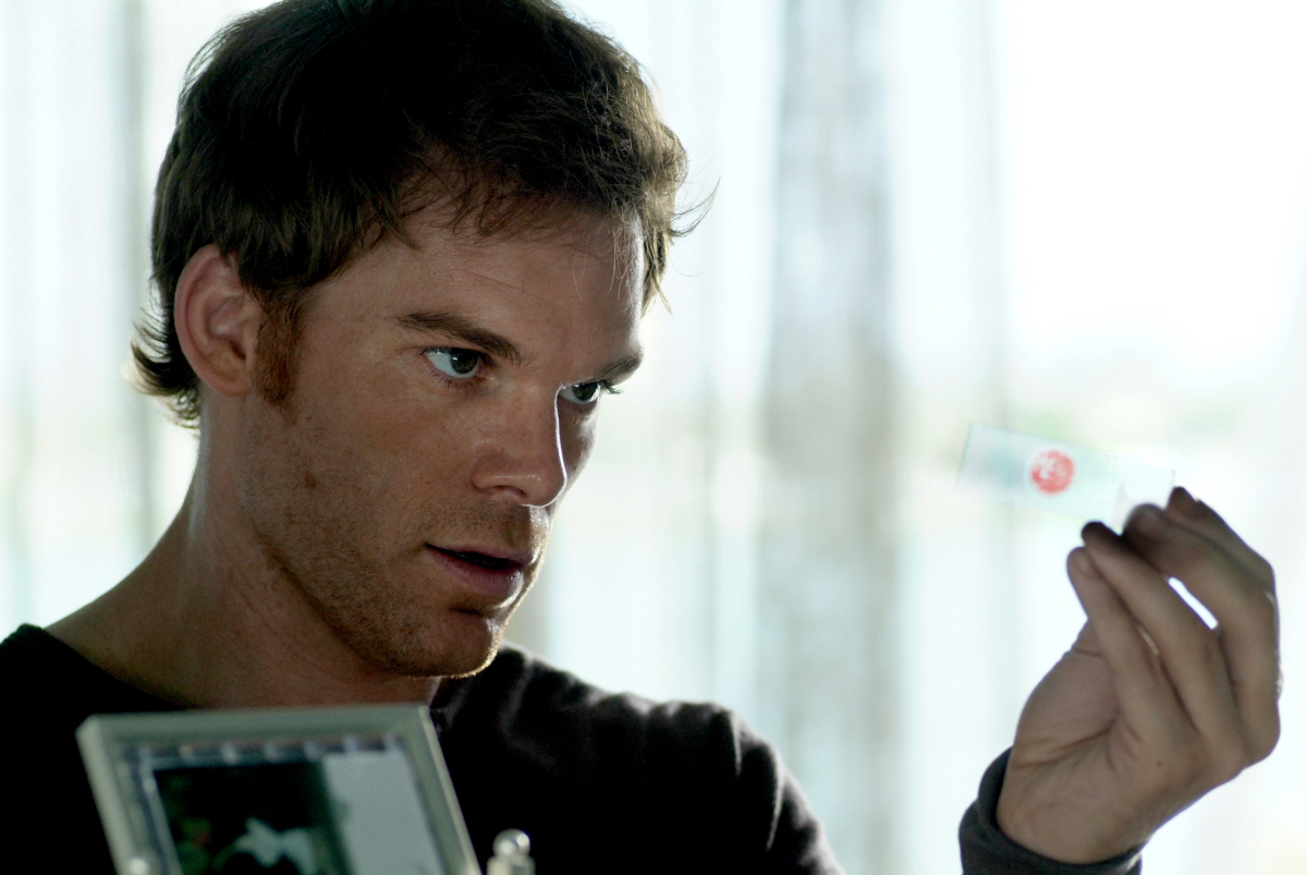 Michael C. Hall holds up a slide of blood in Dexter