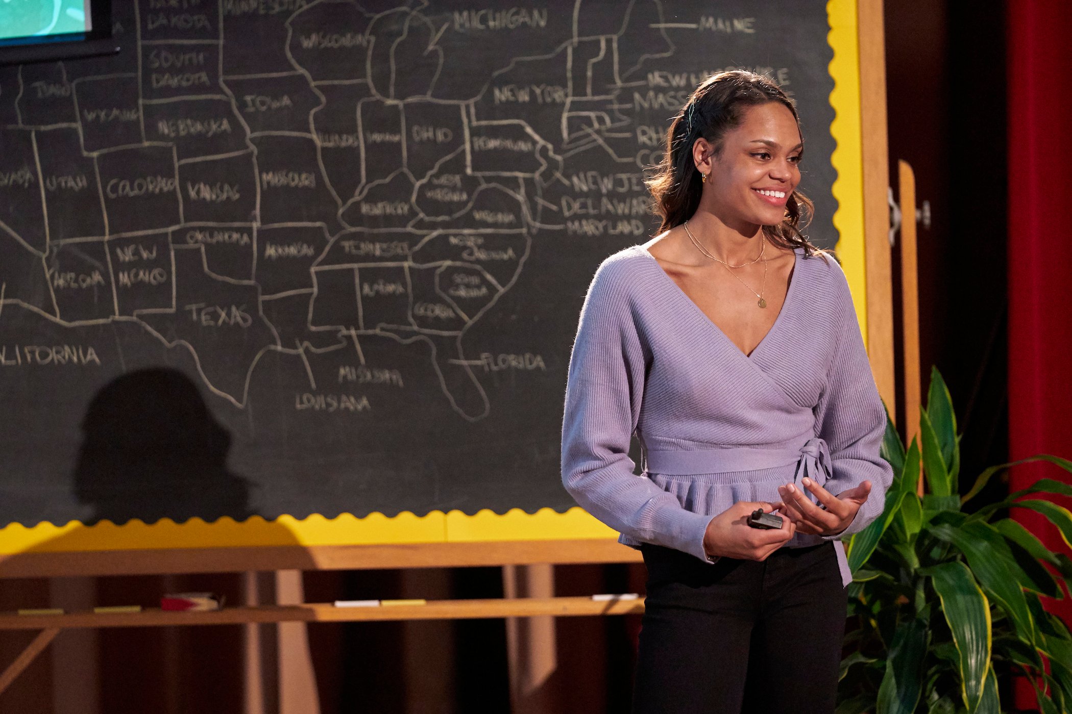 Michelle Young smiling in front of a chalk board on 'The Bachelor.' She's the next star of 'The Bachelorette'