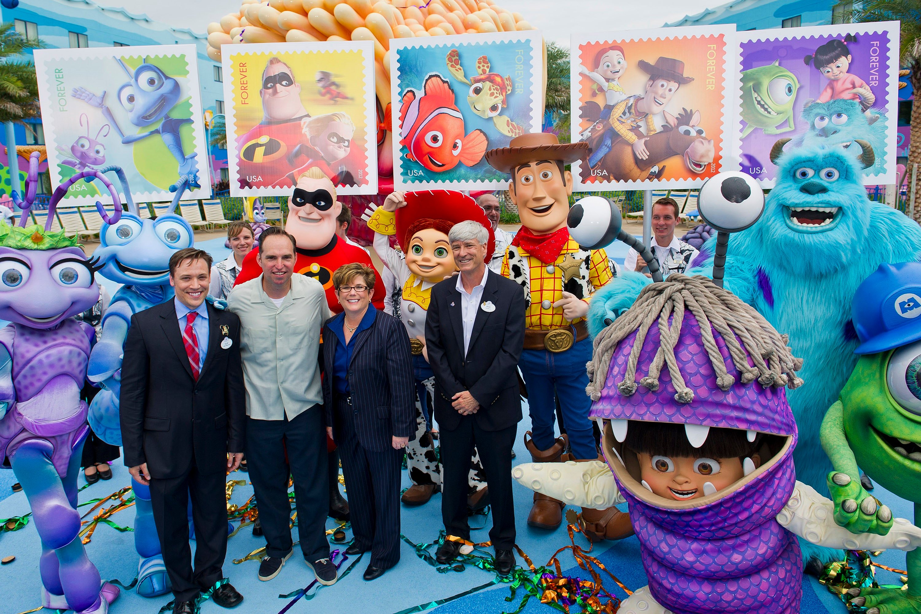 The postal service unveiling a new stamp series at Disneys Art of Animation with characters from Monsters Inc including Boo, Sulley, and Mike along with characters from Finding Nemo, Toy Story, and The Incredibles