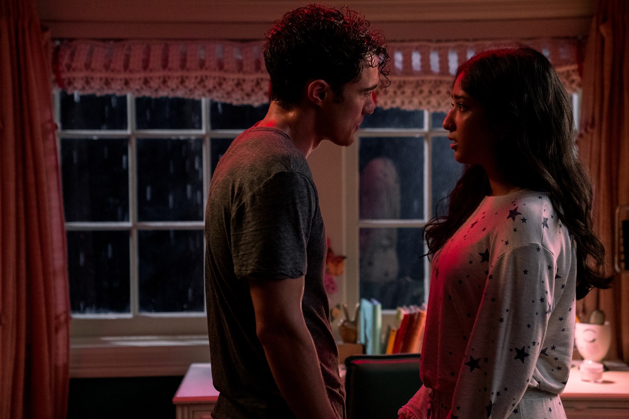 Paxton and Devi stare at one another while standing in Devi's bedroom in 'Never Have I Ever'