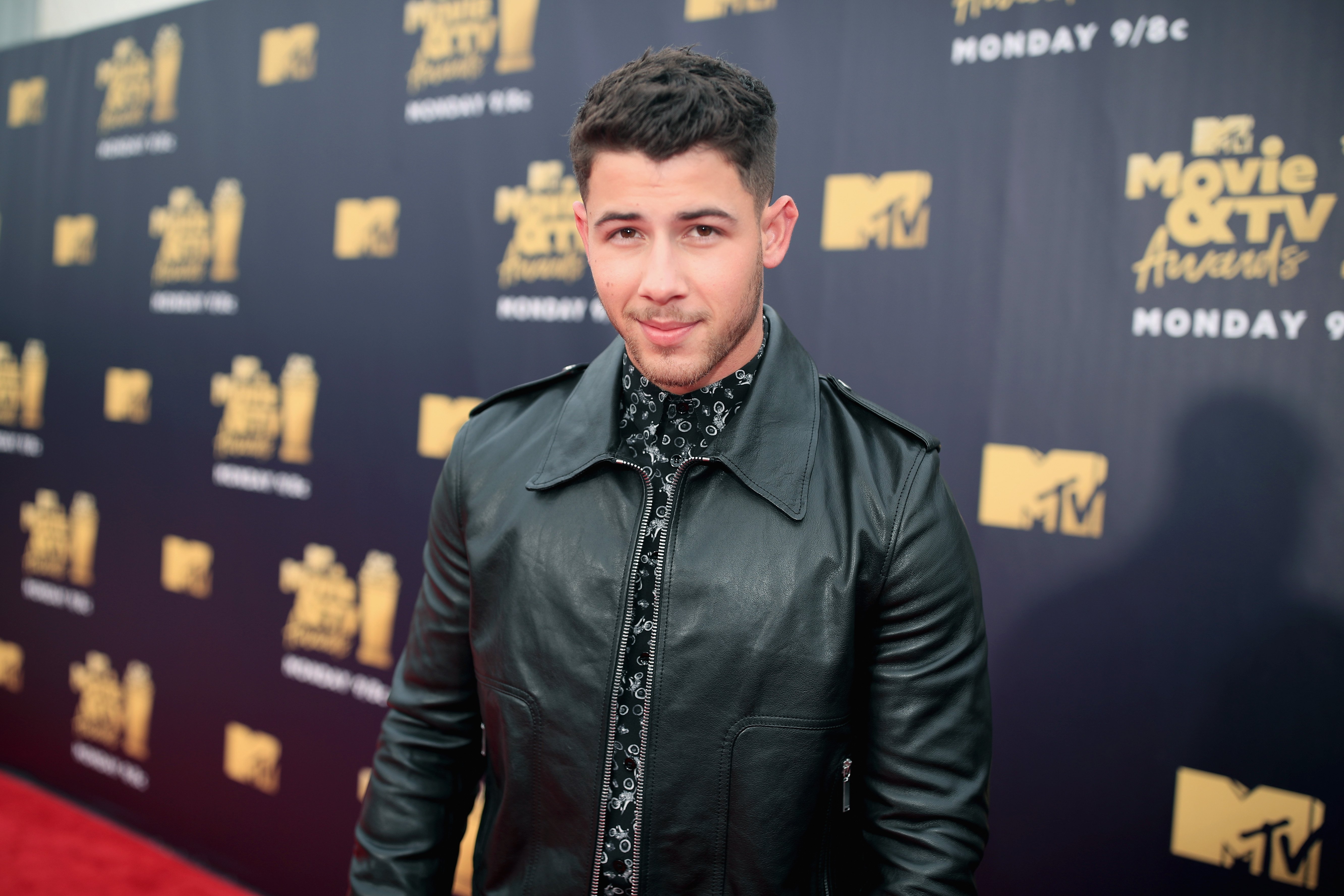 Nick Jonas poses for a photo at the 2018 MTV Movie and TV Awards at Barker Hangar