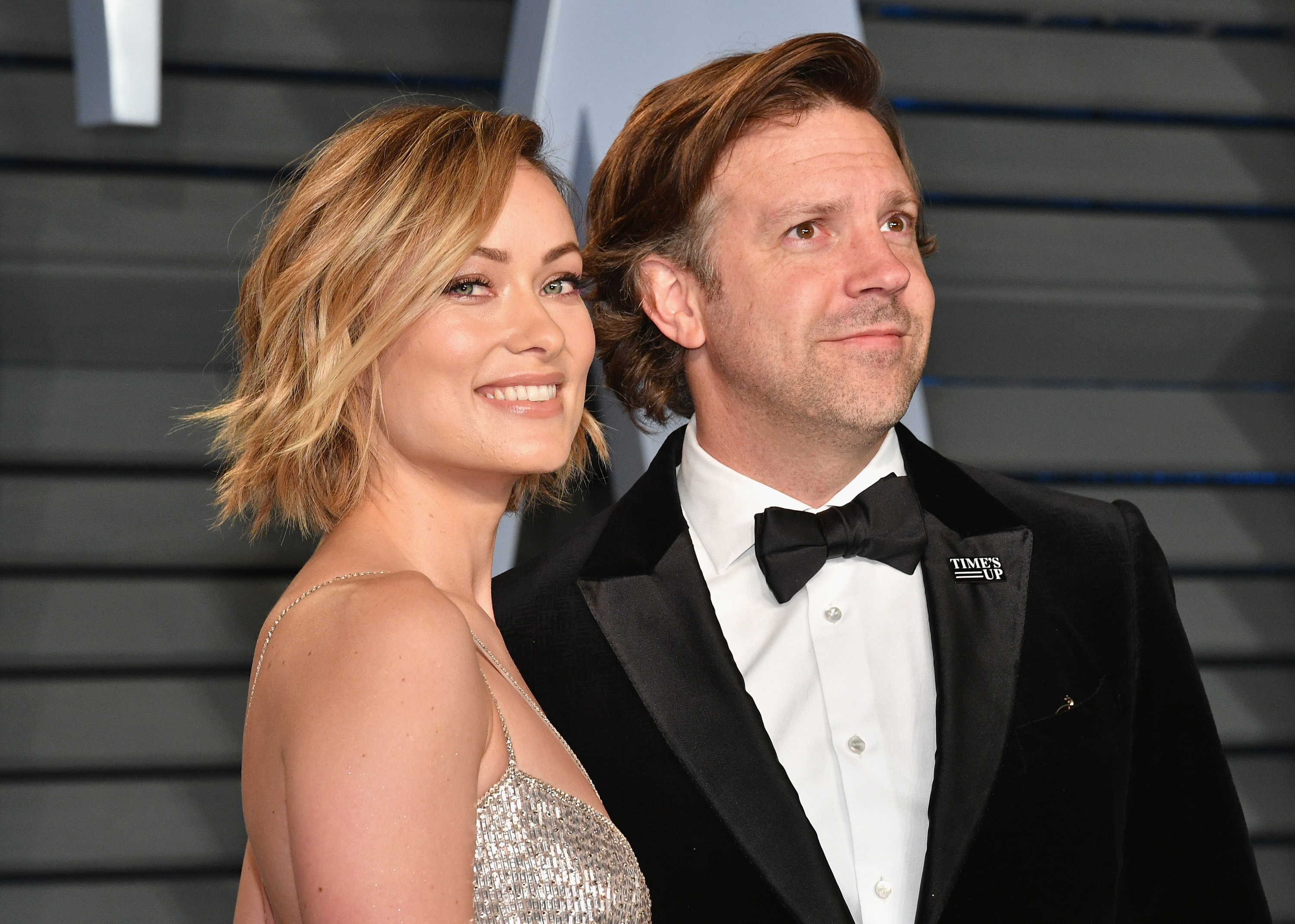 Olivia Wilde and Jason Sudeikis smiling at a 2018 Oscar party