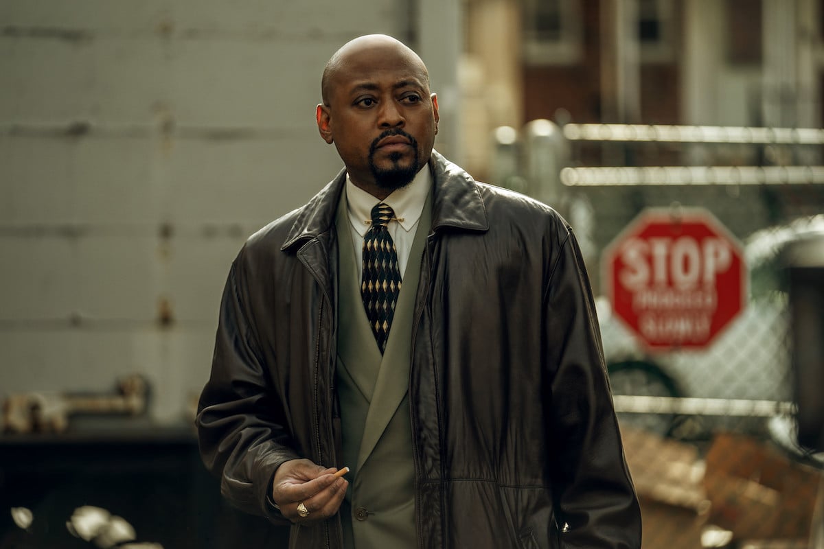 Omar Epps waring a suit and holding a cigarette as Detective Malcolm Howard in 'Power Book III: Raising Kanan'