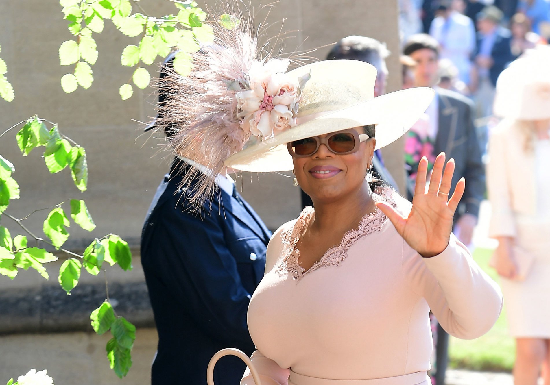 Oprah Winfrey waving to the crowd as she arrives at Prince Harry and Meghan Markle's wedding