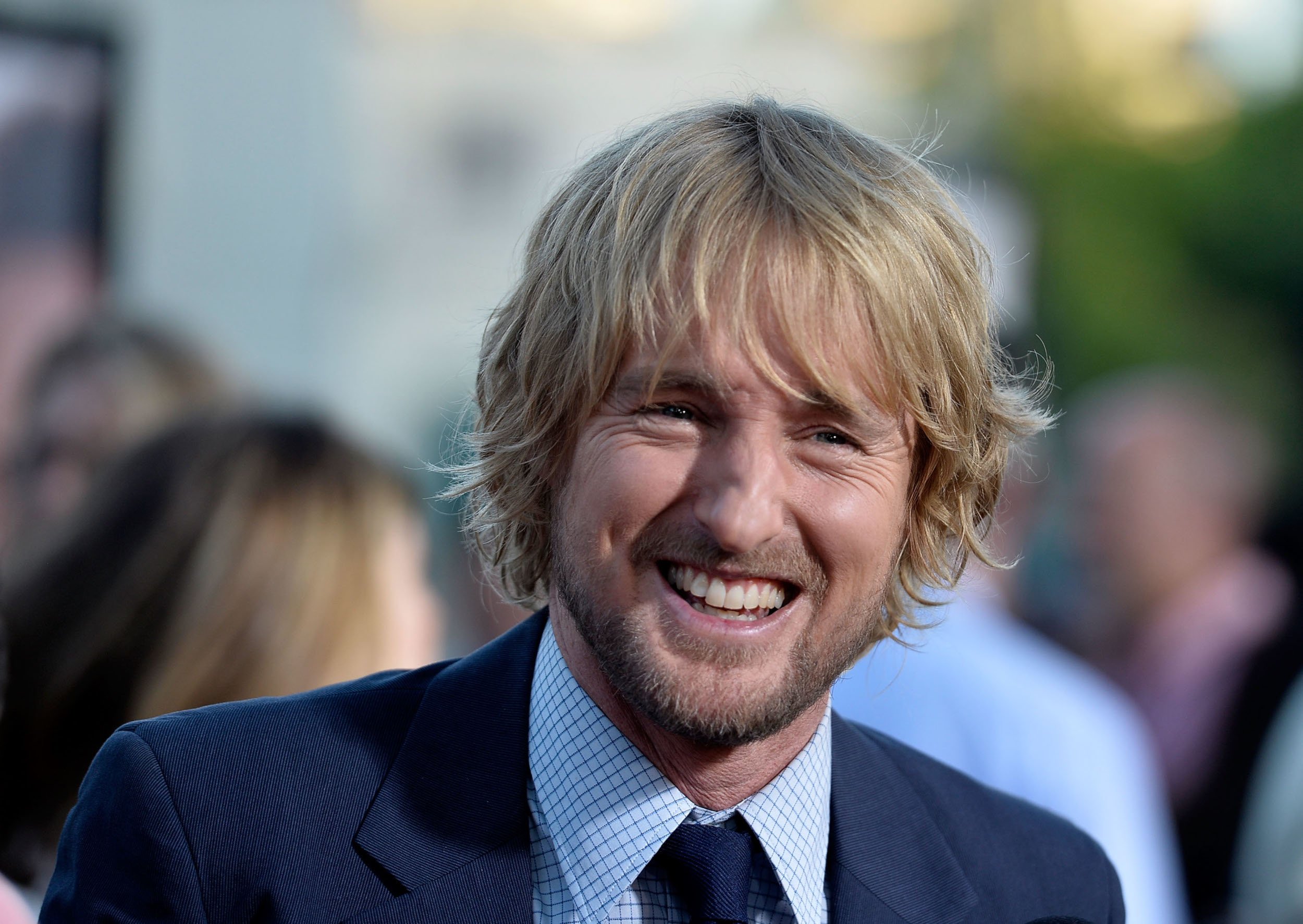 'Loki' star Owen Wilson wearing a blue suit and smiling
