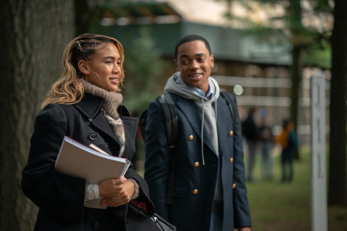 Paige Hurd as Lauren Baldwin and Michael Rainey Jr. as Tariq St. Patrick walking across campus wearing coats in 'Power Book II: Ghost'