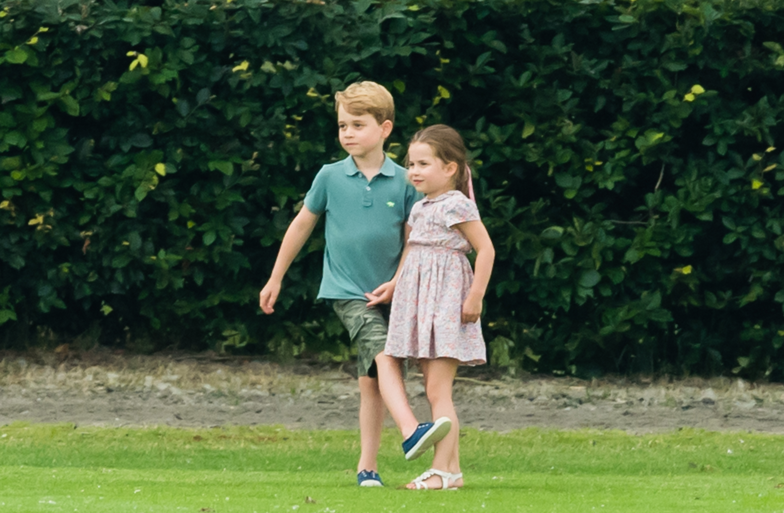 Photo of Prince George and Princess Charlotte playing together at The King Power Royal Charity Polo Day