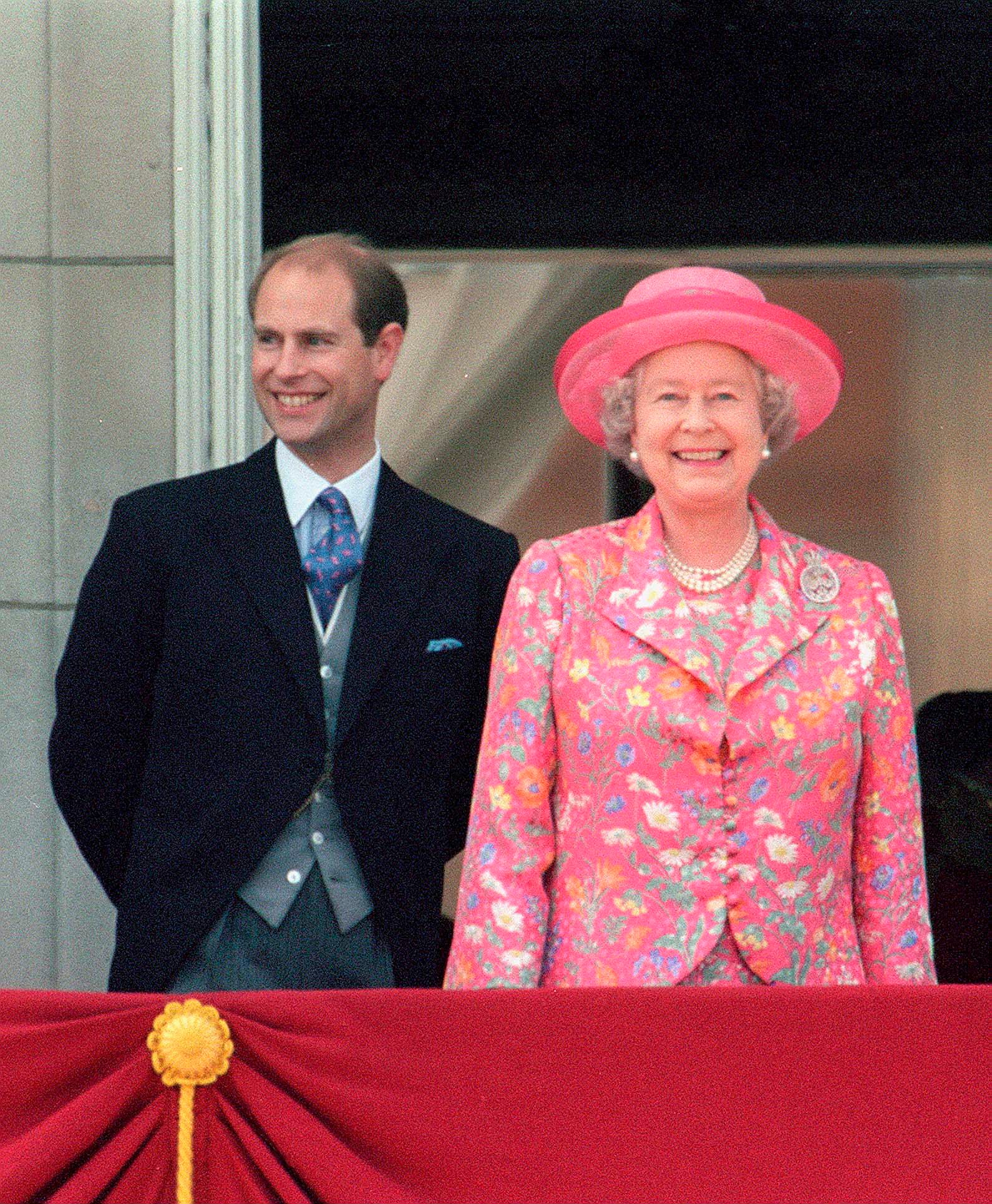 Prince Edward with his mother Queen Elizabeth II smiling from the balcony of Buckingham Palace after watching Trooping the Colour