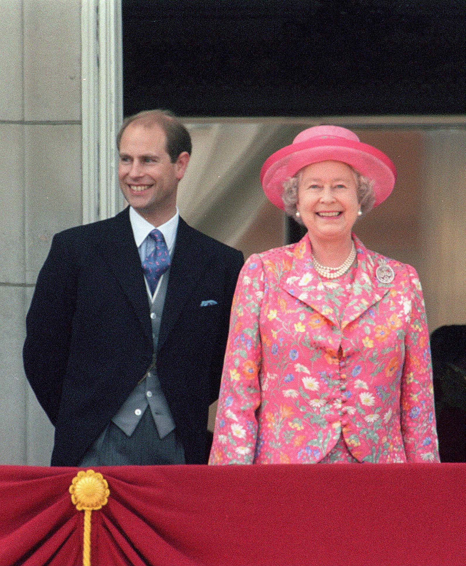 Prince Edward with his mother Queen Elizabeth II smiling from the balcony of Buckingham Palace after watching Trooping the Colour