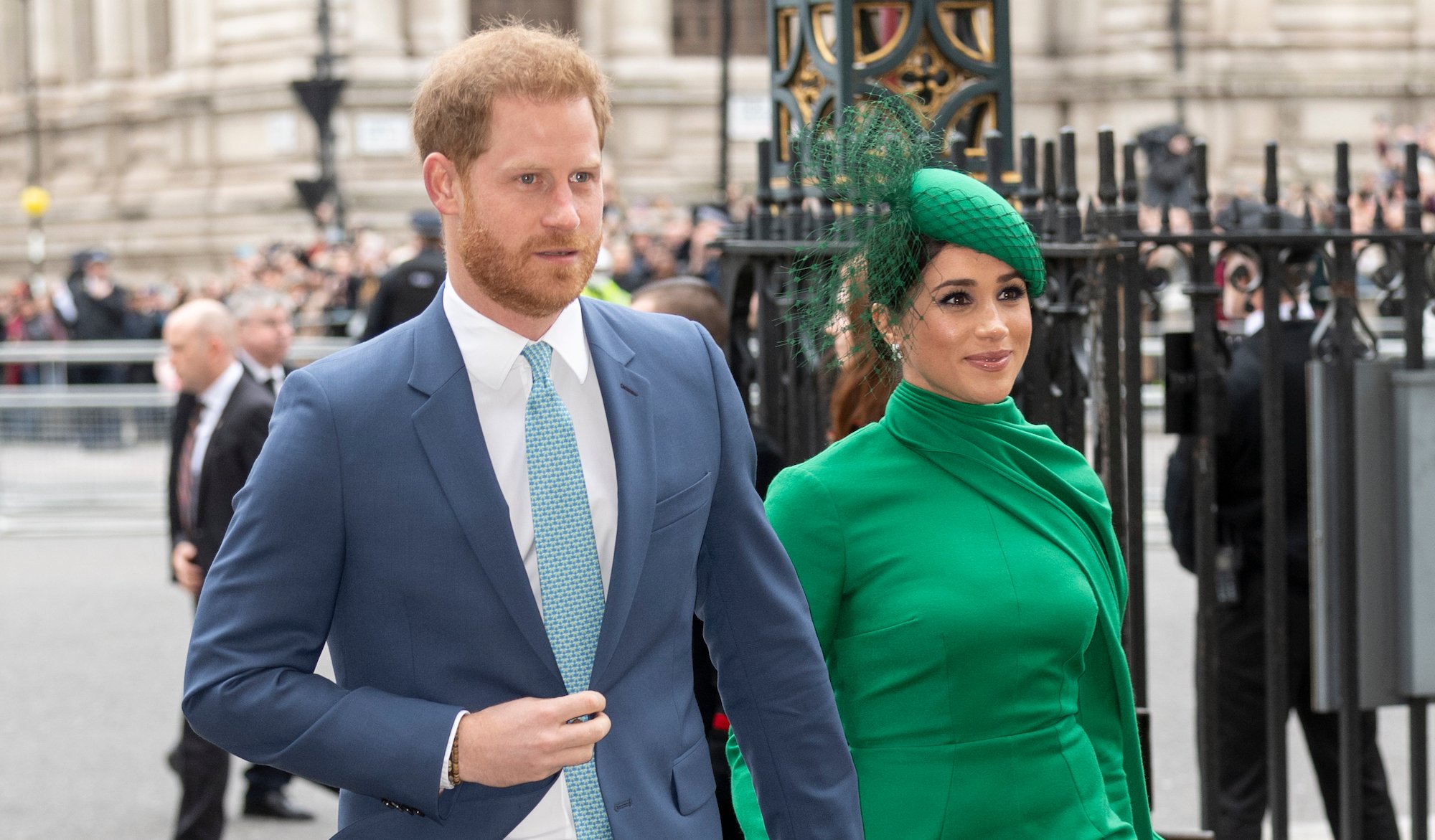 Prince Harry and Meghan Markle hold hands as they arrive at their final engagement as senior working royals in March 2021