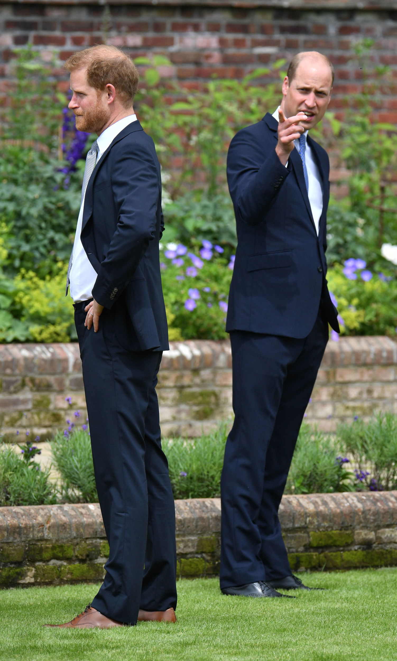 Prince Harry and Prince William standing with their backs to each other during the unveiling of a Princess Diana's statue