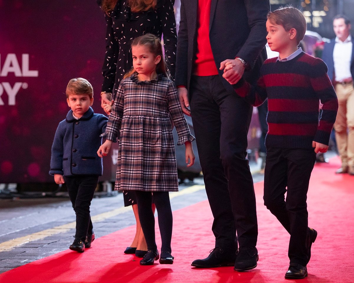 Prince Louis, Princess Charlotte, and Prince George walking on red carpet with their parents at London's Palladium Theatre