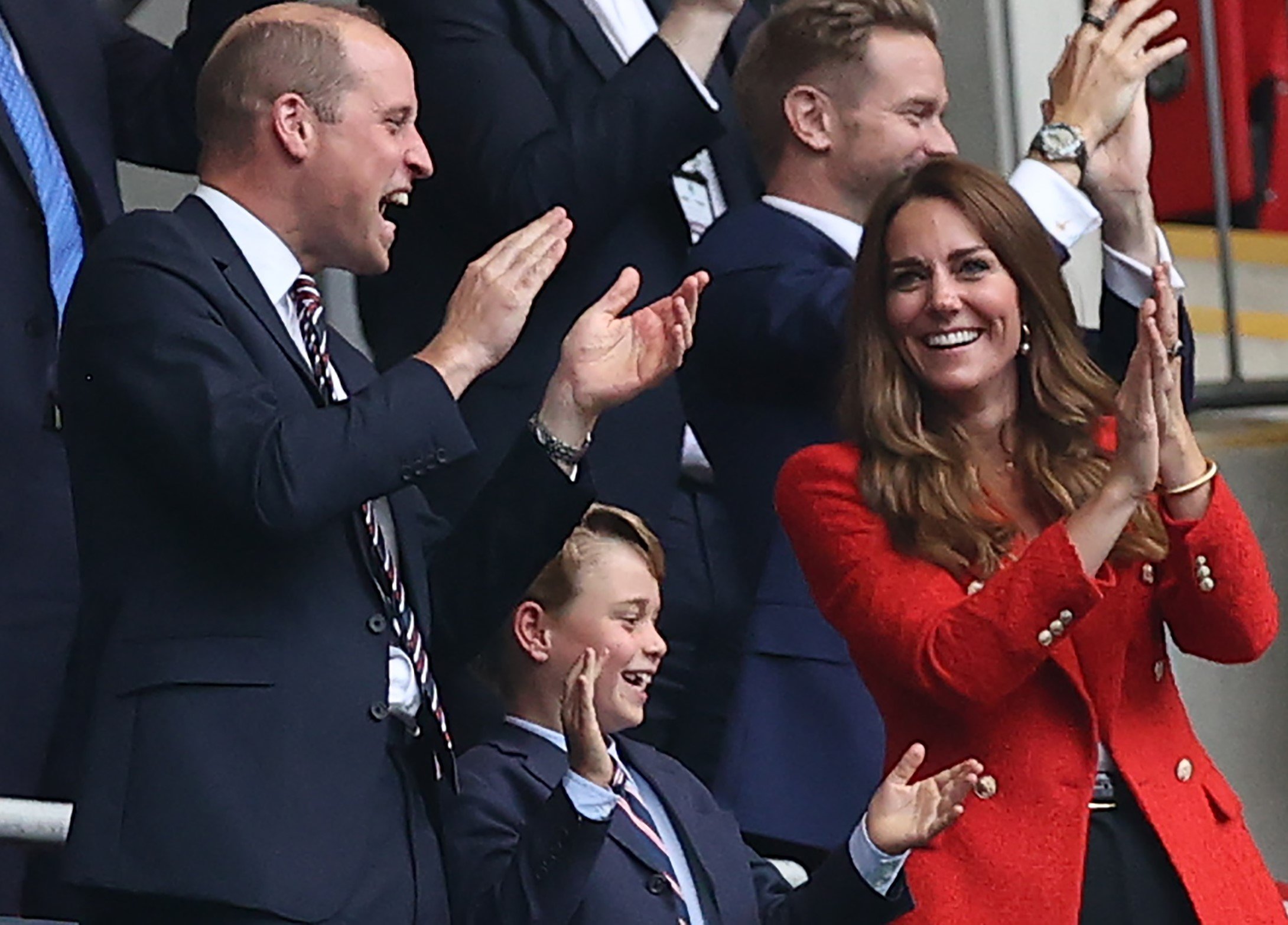 Prince William, Kate Middleton, and their son Prince George clapping and cheering during the Euro Cup