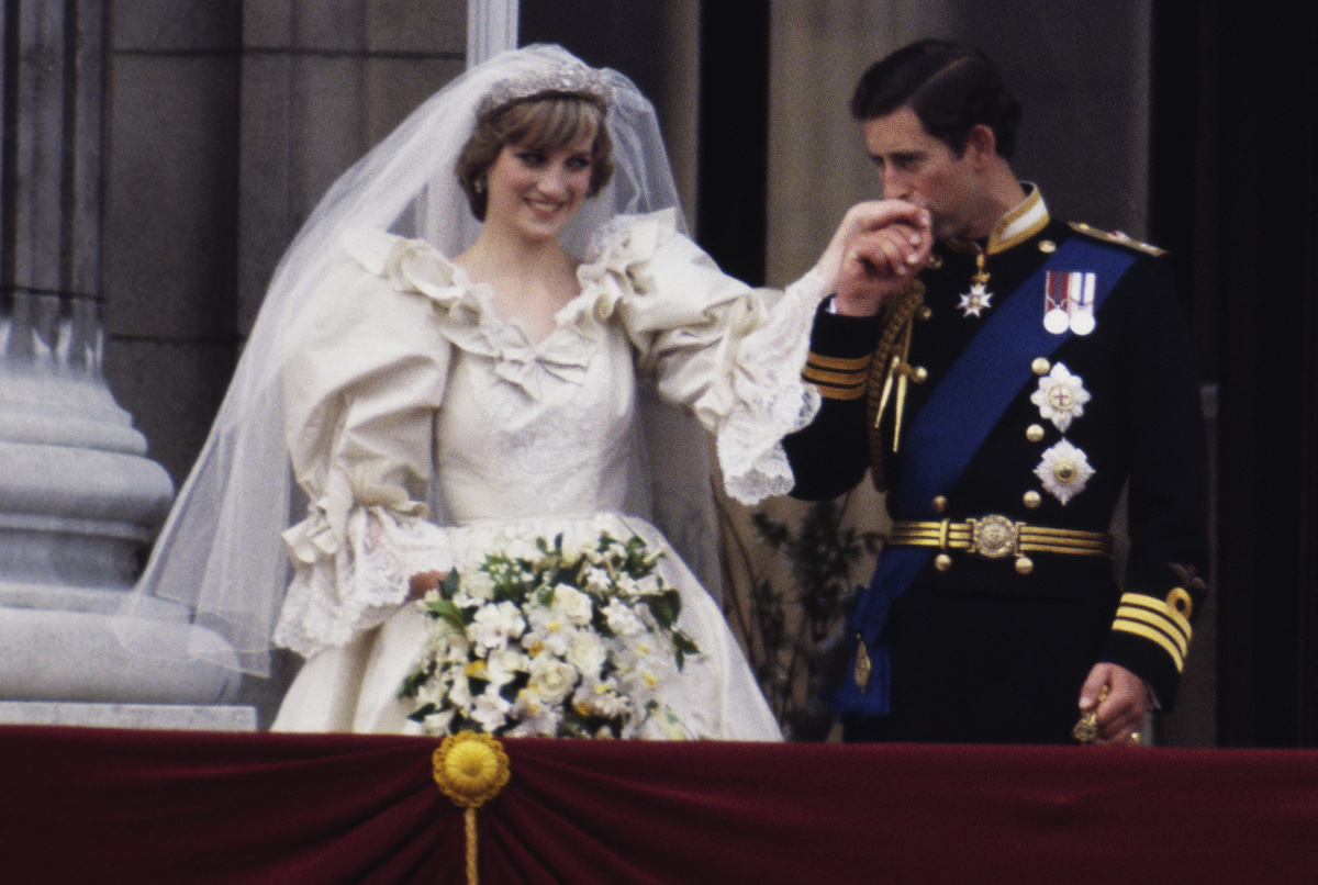 The Prince and Princess of Wales on the balcony of Buckingham Palace on their wedding day, 29th July 1981. Diana wears a wedding dress by David and Elizabeth Emmanuel and the Spencer family tiara.