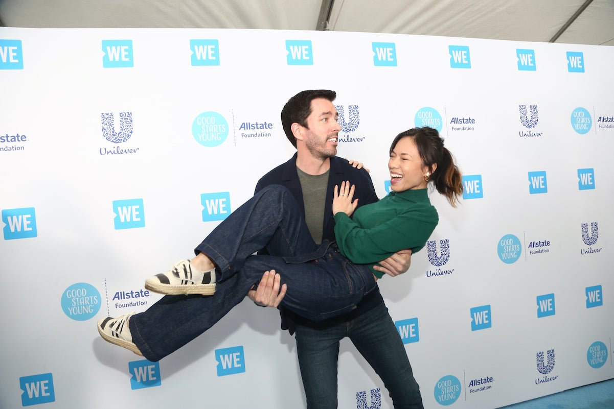 Drew Scott holding Linda Phan on the red carpet