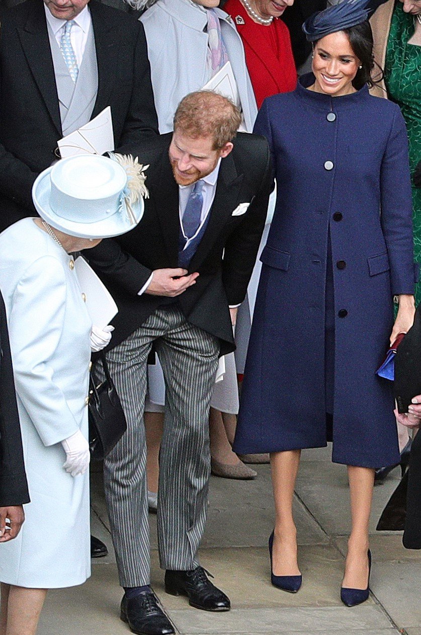  Queen Elizabeth II talks with Prince Harry and Meghan Markle outside chapel after Princess Eugenie's wedding