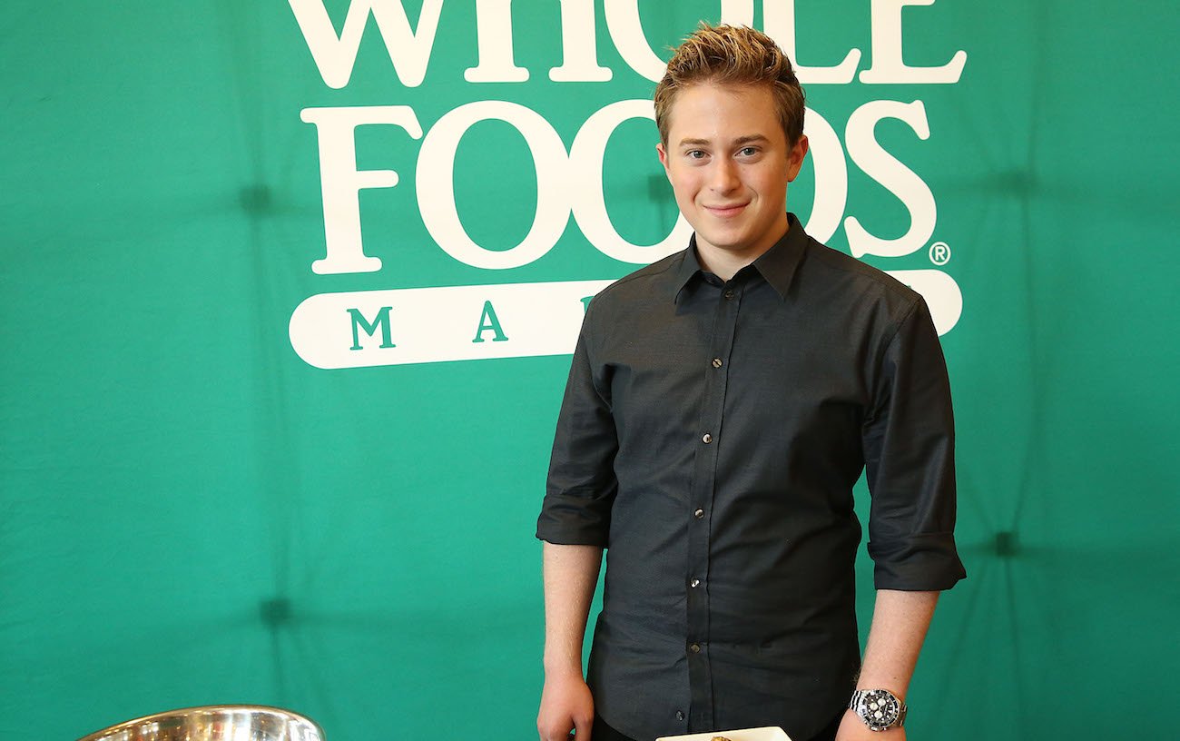 Reed Alexander standing in front of green background