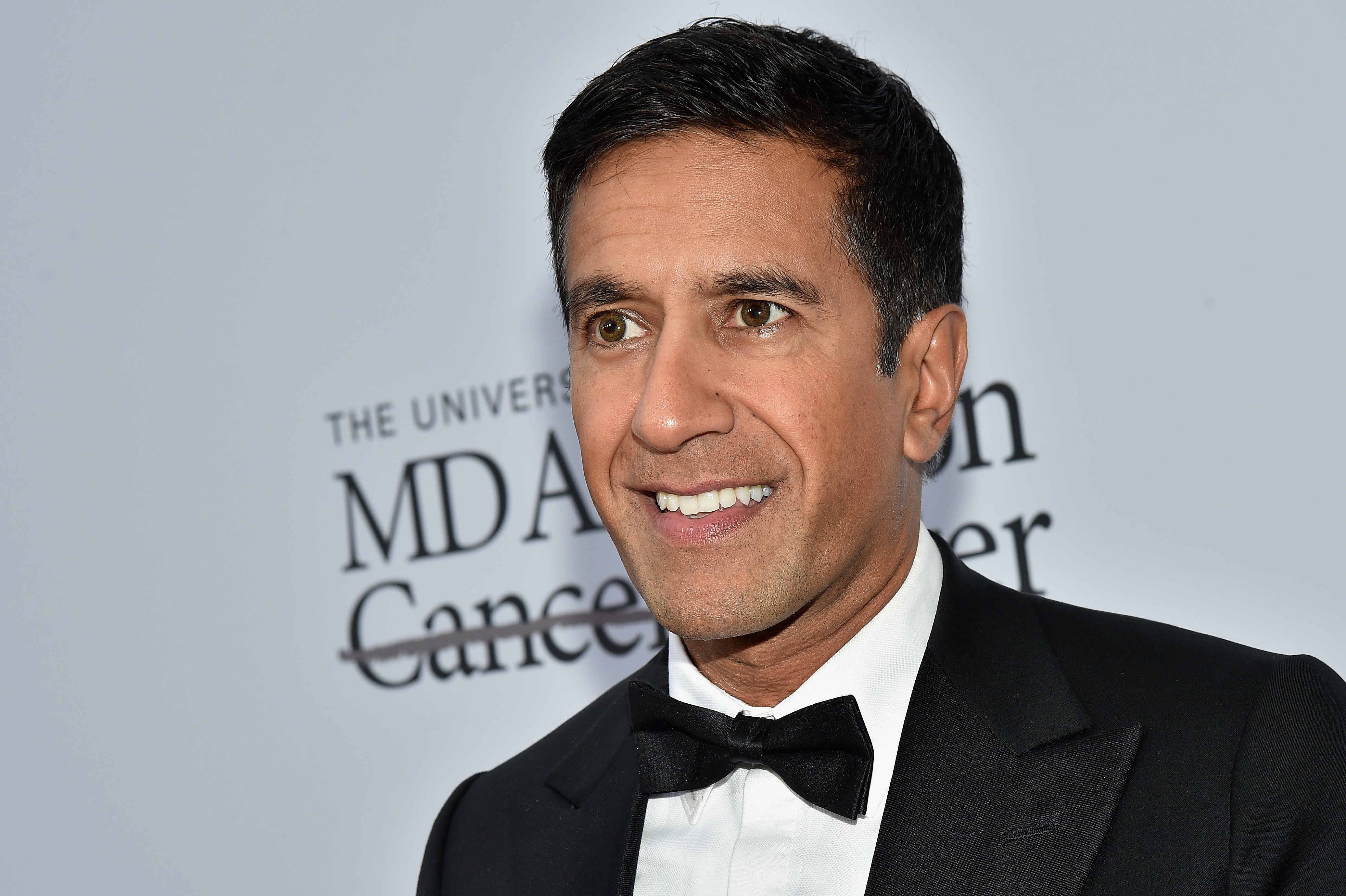 CNN's Dr. Sanjay Gupta wears a tuxedo and a smile at a 2016 event.