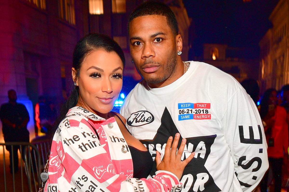 Shantel Jackson hugs Nelly while posing for a photo at a party