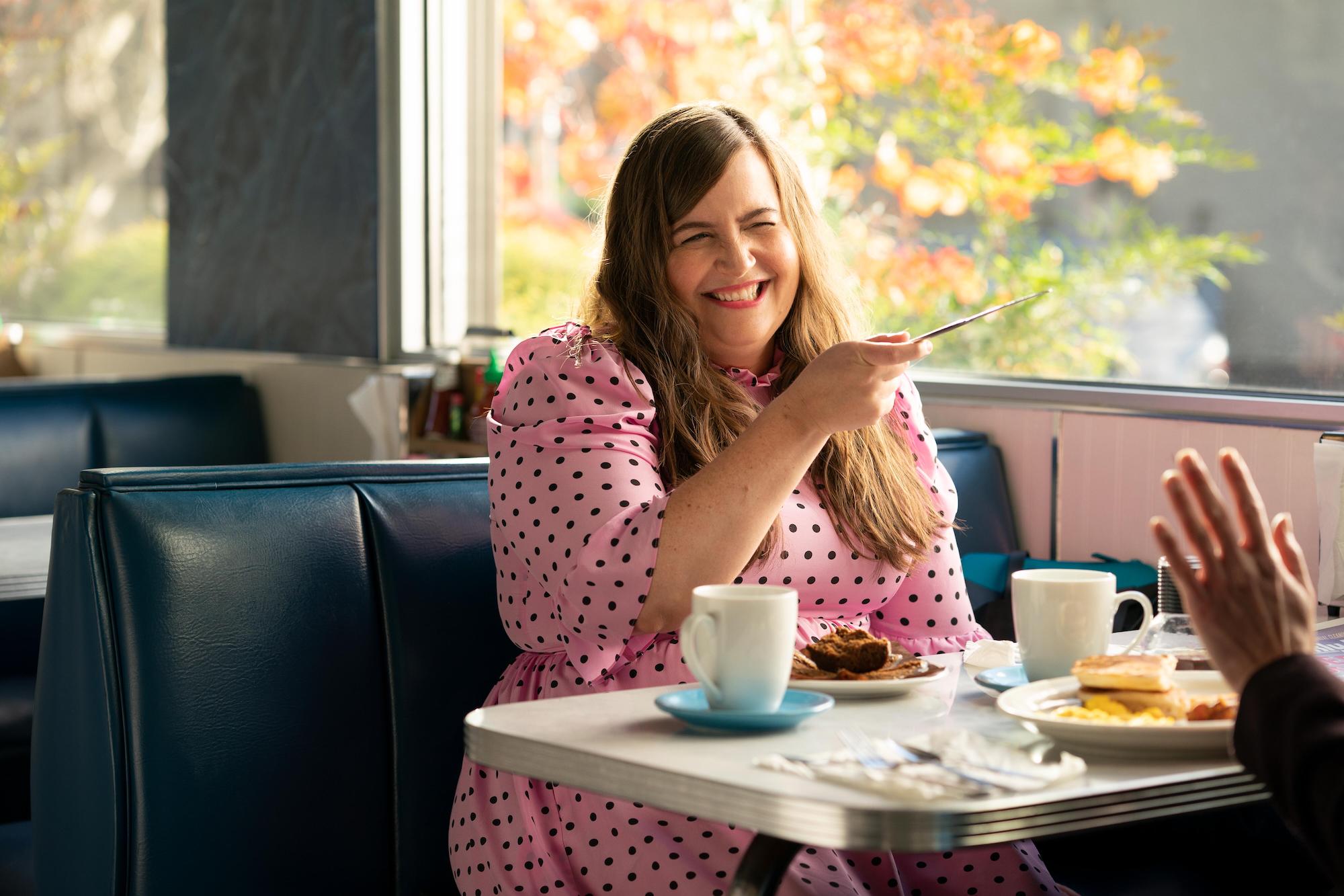 Aidy Bryant on 'Shrill' laughing, holding a dinner knife