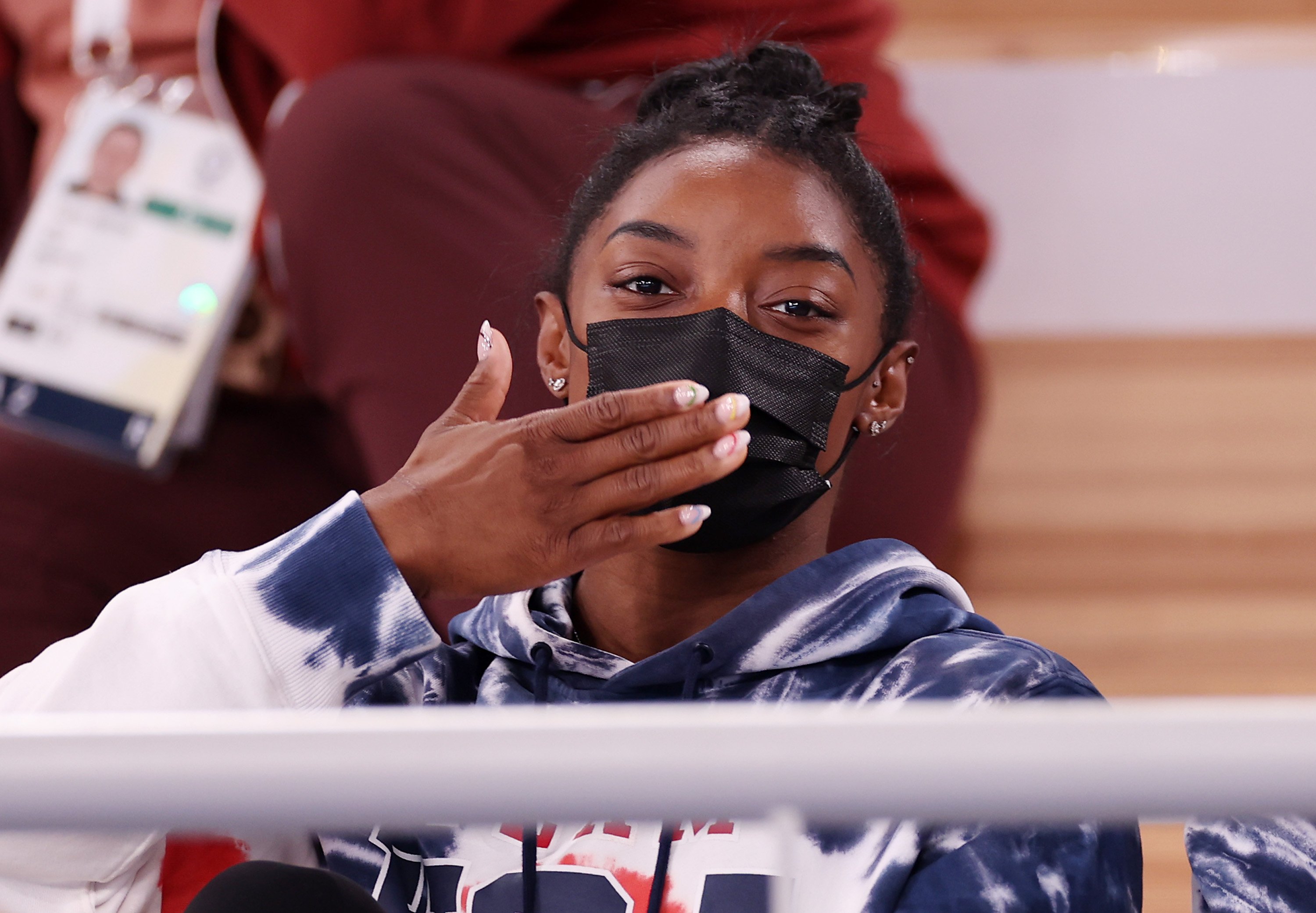 Simone Biles blows a kiss in the stands
