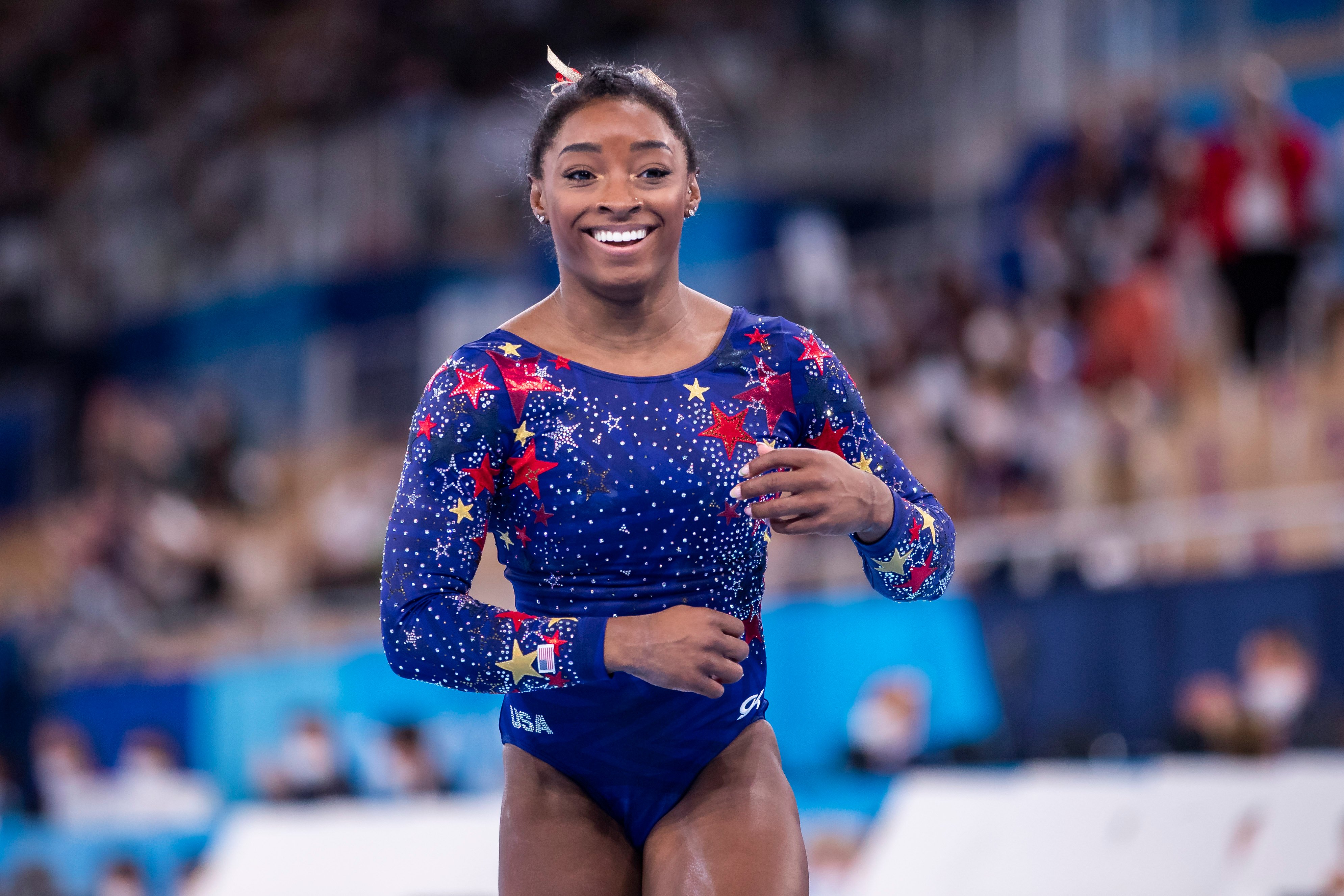 Simone Biles smiles during the qualification round of the women's gymnastics in Tokyo