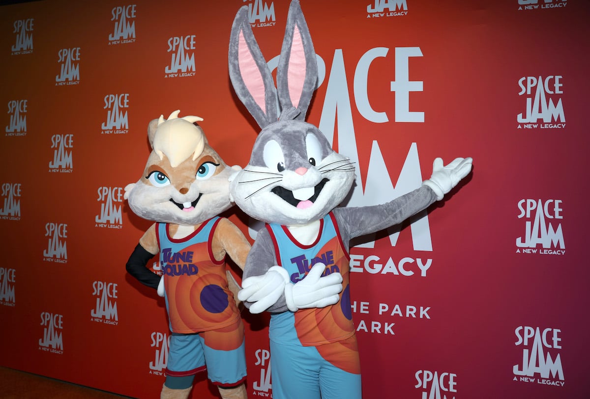 Lola Bunny and Bugs Bunny pose in front of the ‘Space Jam: A New Legacy’ logo